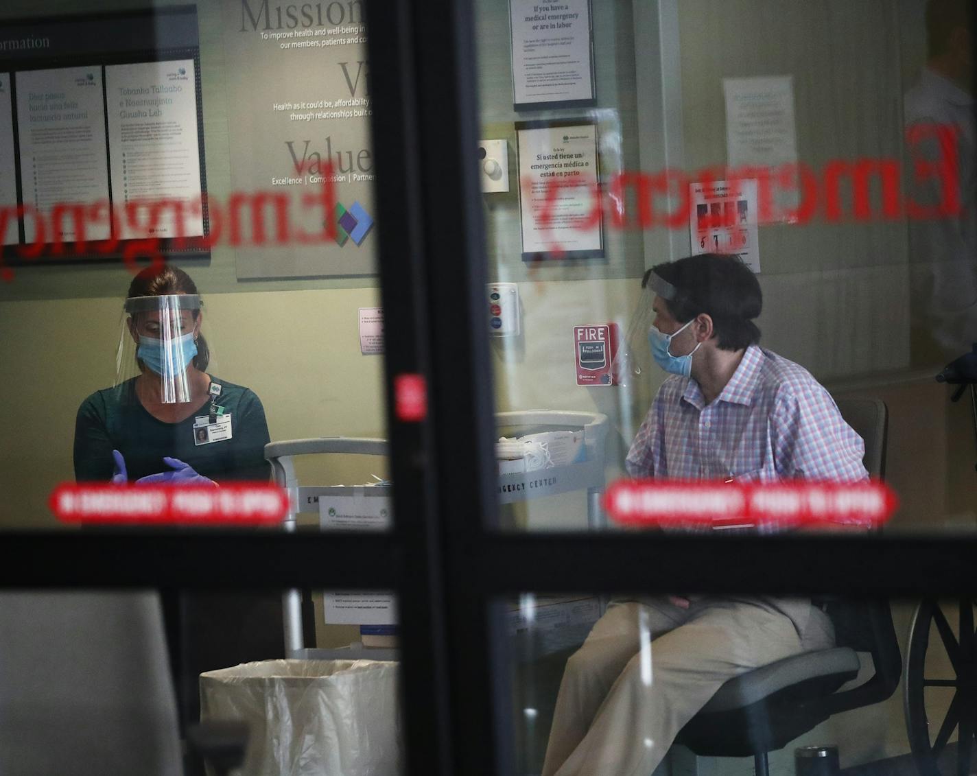 Screeners wait inside the entrance to the Park Nicollet Methodist Hospital emergency room, where they check those arriving for COVID symptoms before determining where they will go within the hospital and seen Thursday, June 4, 2020, in St. Louis Park, MN.] DAVID JOLES • david.joles@startribune.com Hospitals are urging people with medical emergencies to go to the ER again, but will anyone actually go? We're visiting hospital emergency departments in the Twin Cities this week to get a first-hand l