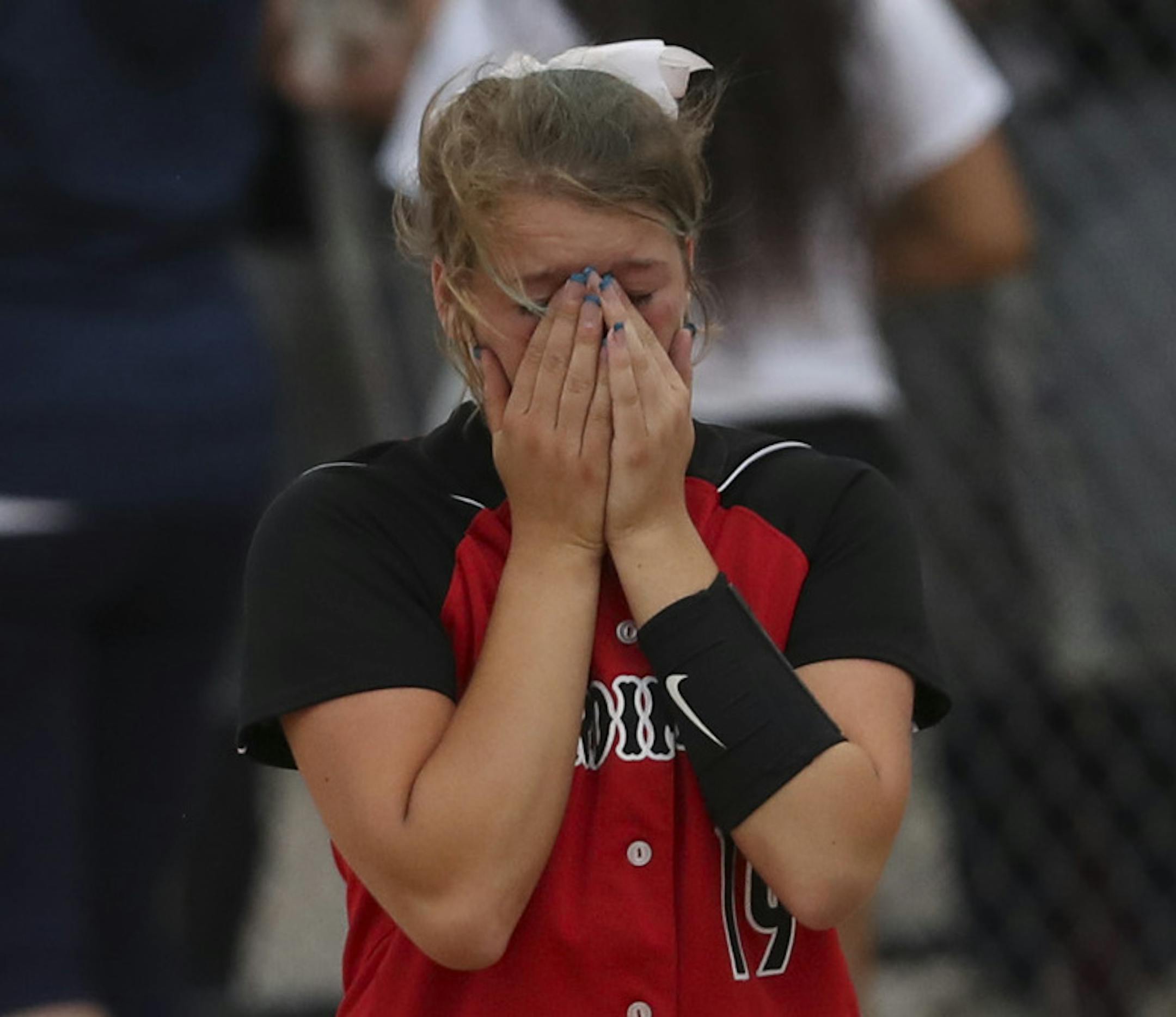 Annandale pitcher Sarah Johnson, left, and her catcher, Bree Seagraves walked back to their dugout while St. Peter's celebration carried on behind them. ] JEFF WHEELER ï jeff.wheeler@startribune.com The Minnesota State High School League's girls' softball state tournament began Thursday, June 7, 2018 at Caswell Park in North Mankato. It took 10 innings, but St. Peter defeated Annandale 5 - 2 in their Class 2A semifinal game to advance to Friday's championship.