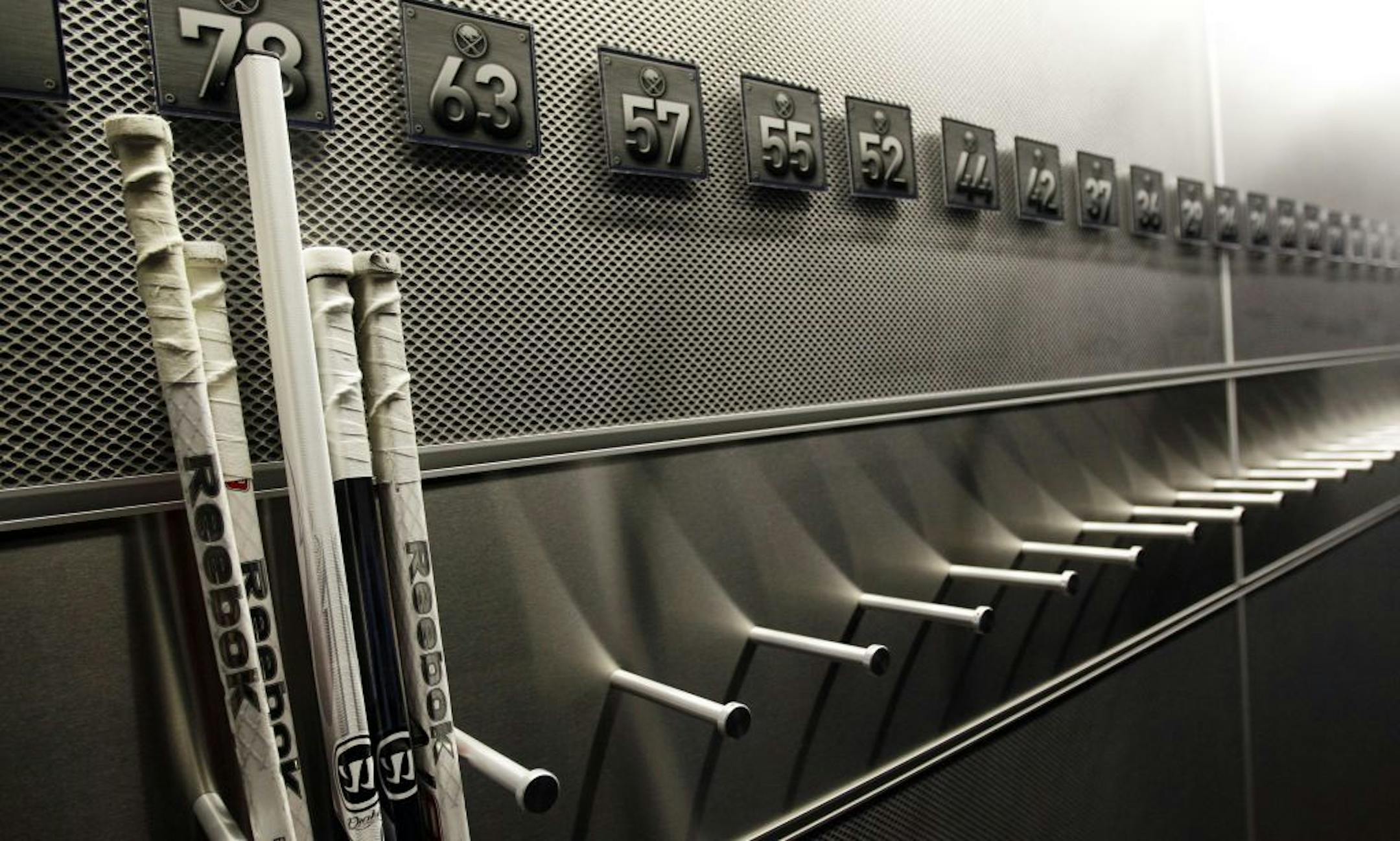 A nearly empty hockey stick rack in the Buffalo Sabres locker room.
