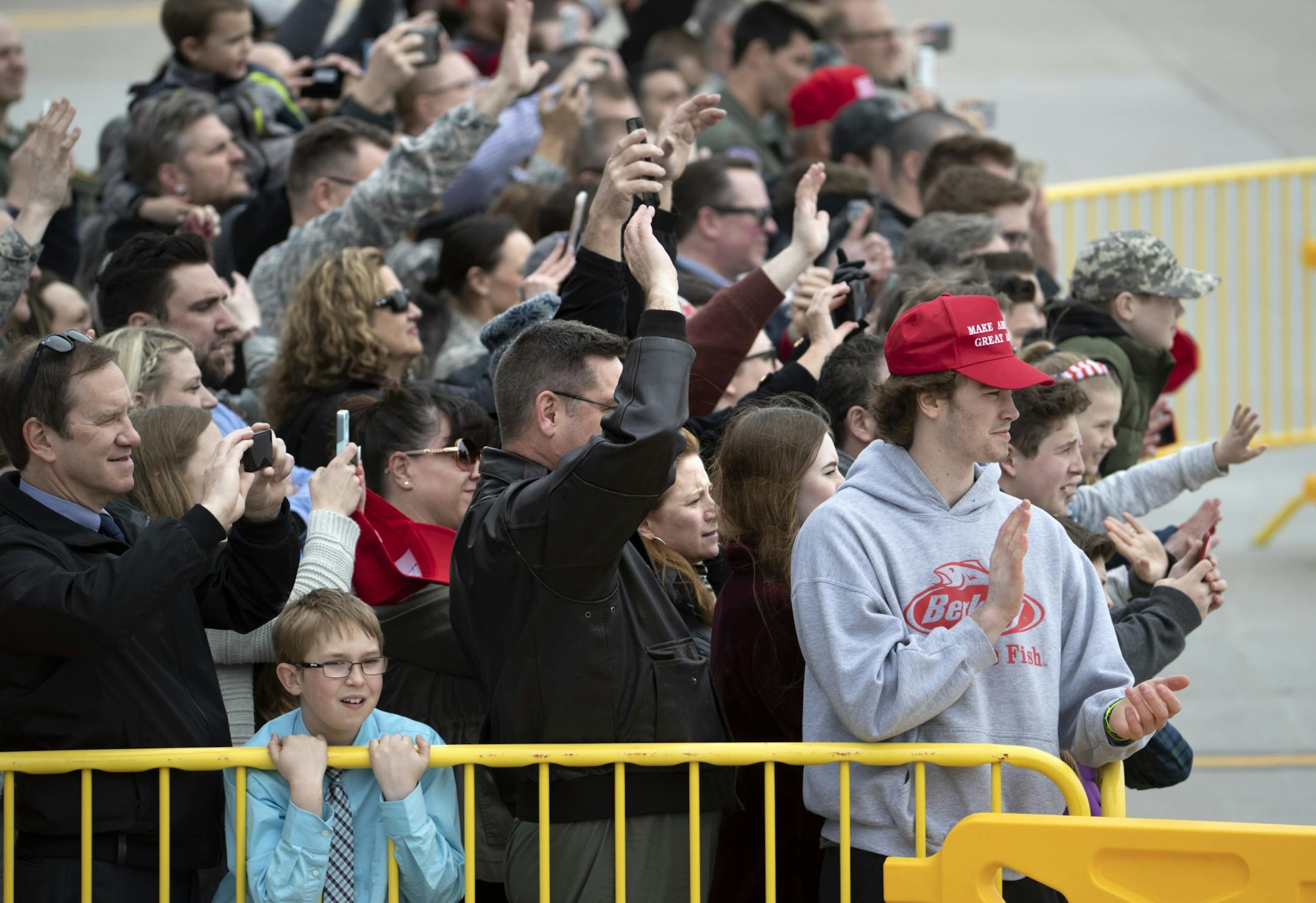 President Donald Trump landed at the Minneapolis St. Paul International Airport at 12:45 Central time Monday, headed to an afternoon visit at a Burnsville truck and equipment company for a roundtable discussion on tax cuts and the U.S. economy. Here, a small group of invited guests wave to the President as he arrives on Air Force One.