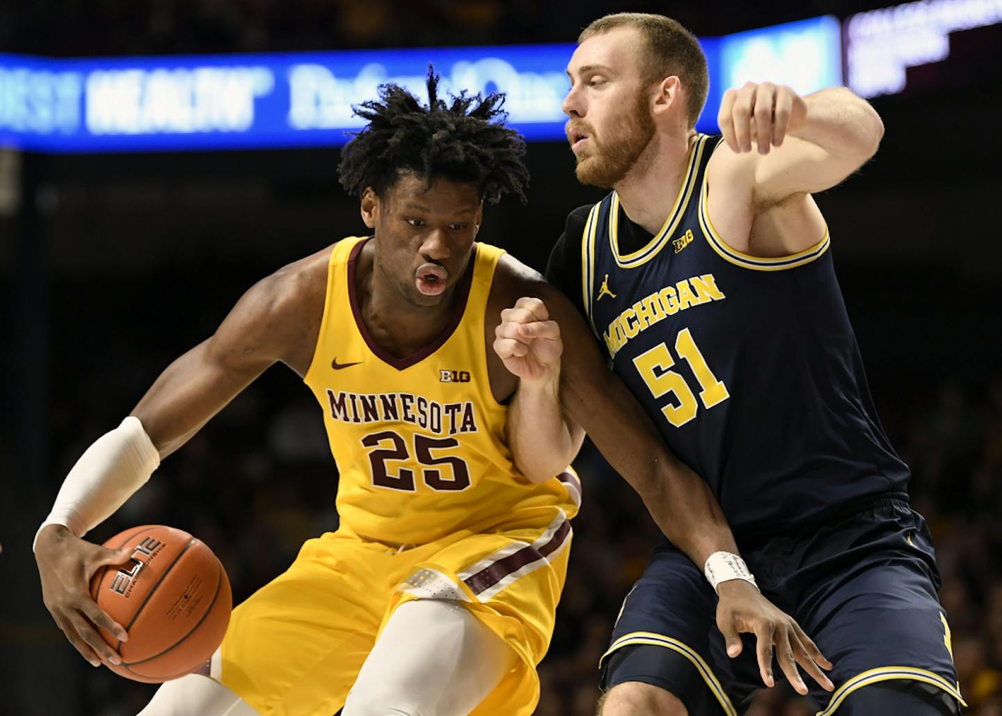 Gophers sophomore center Daniel Oturu worked against Michigan's Austin Davis (51) during the first half Sunday. Oturu scored a career-high 30 points in the Gophers' 75-67 upset of the No. 19 Wolverines at Williams Arena.