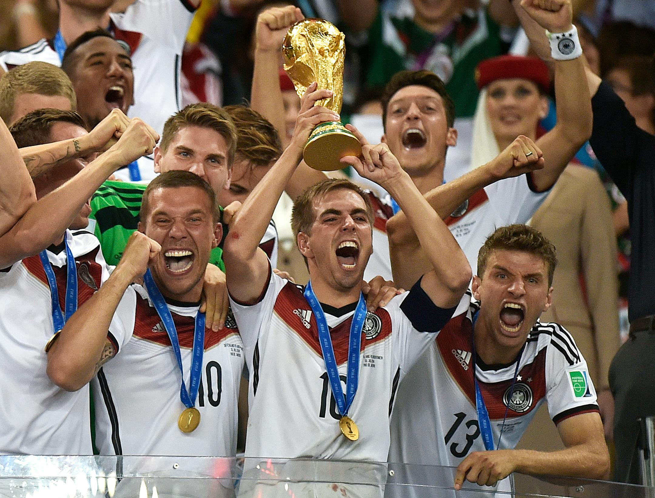 In this July 13, 2014, file photo, Germany's Philipp Lahm (16) raised the trophy after the World Cup final soccer match between Germany and Argentina at the Maracana Stadium in Rio de Janeiro, Brazil. After raising the World Cup eight miles from Copacabana Beach four years ago, Germany hopes to lift the trophy four miles from the Kremlin on July 15 and become the first repeat champion in more than a half-century.