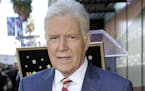 FILE - Alex Trebek, host of "Jeopardy!" attends a ceremony honoring the show's executive producer Harry Friedman with a star on the Hollywood Walk of 