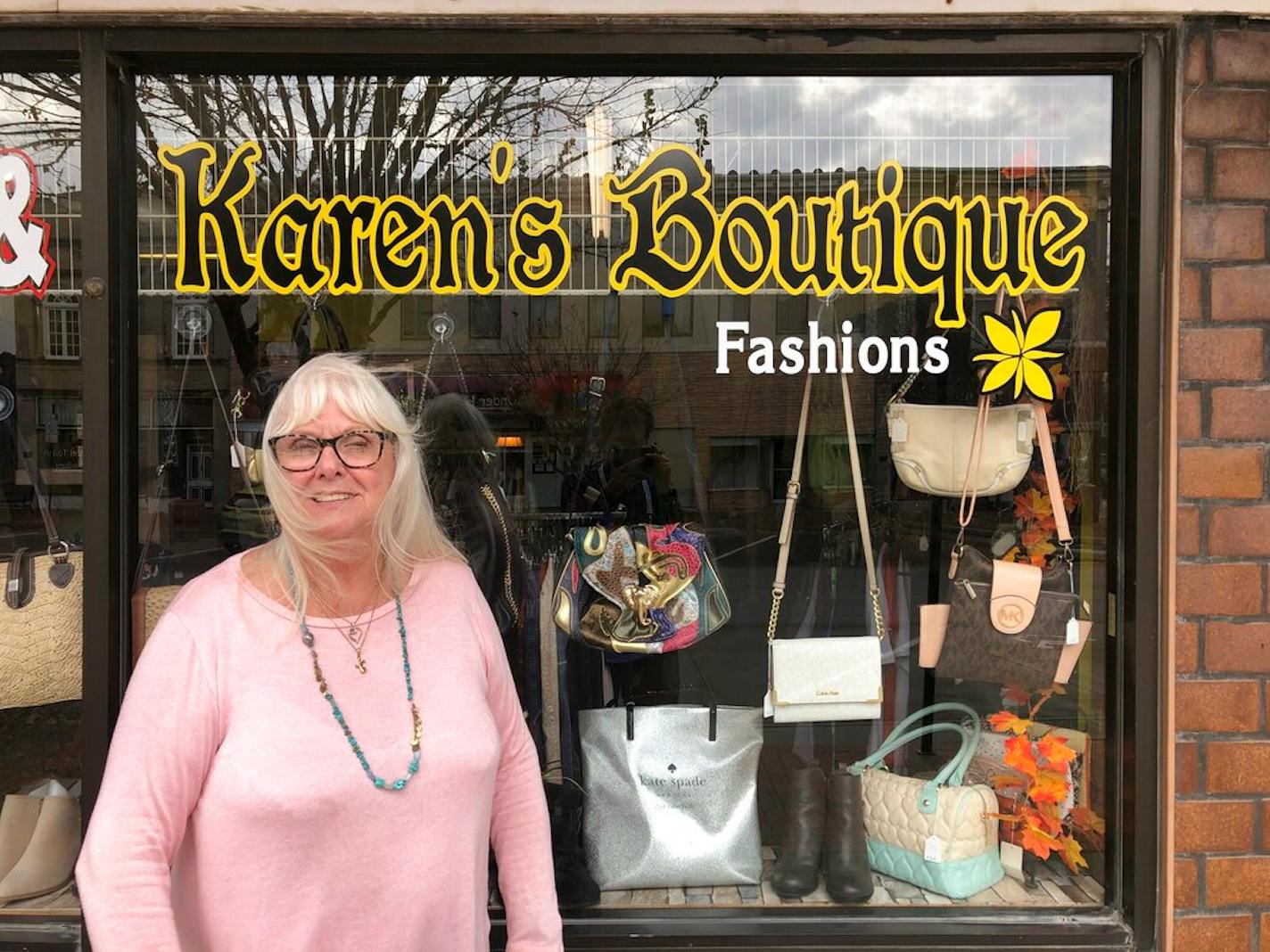 Karen Prohaska, 76, stands outside her purse and jewelry shop in downtown Plattsmouth, Nebraska, on Monday, Nov. 9, 2020. Prohaska says she hopes not to get the virus, but she usually doesn't wear a mask in her store because it hinders her breathing. She believes some people are overreacting to the threat.