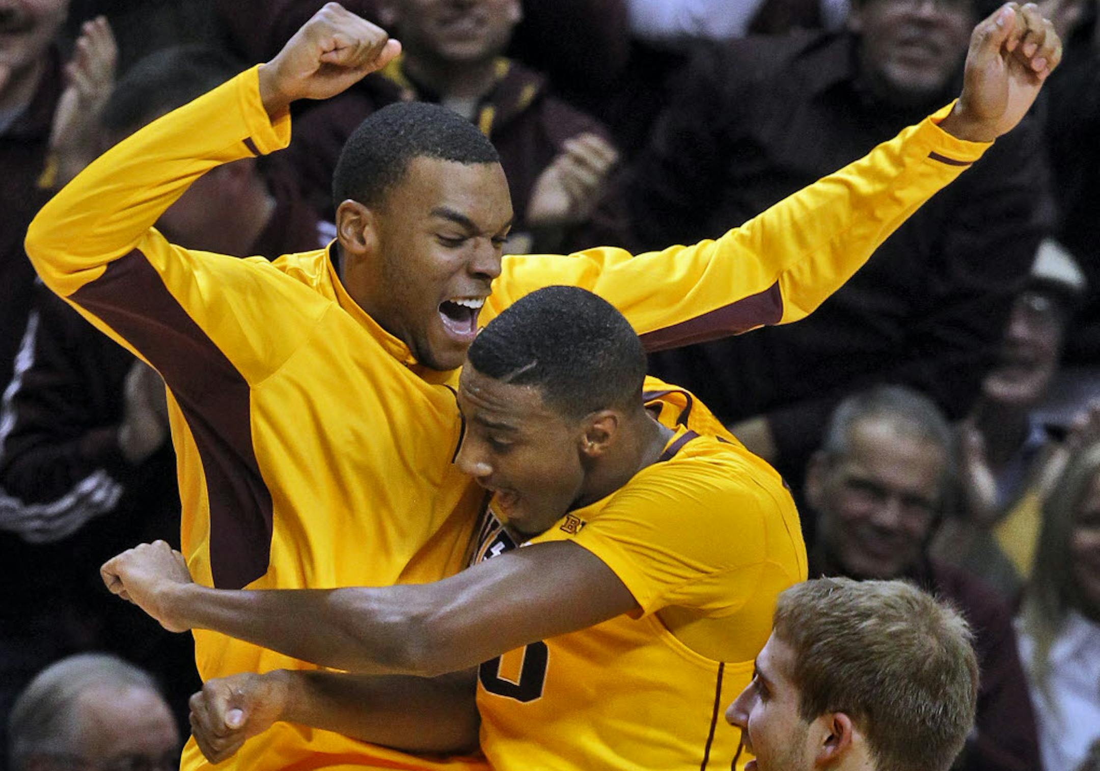 Andre Hollins, left, celebrated with teammate Austin Hollins after Austin hit a three-point shot.