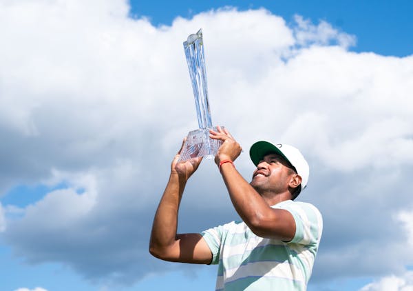 Tony Finau held his trophy after winning the 3M Open last year at the TPC in Blaine.