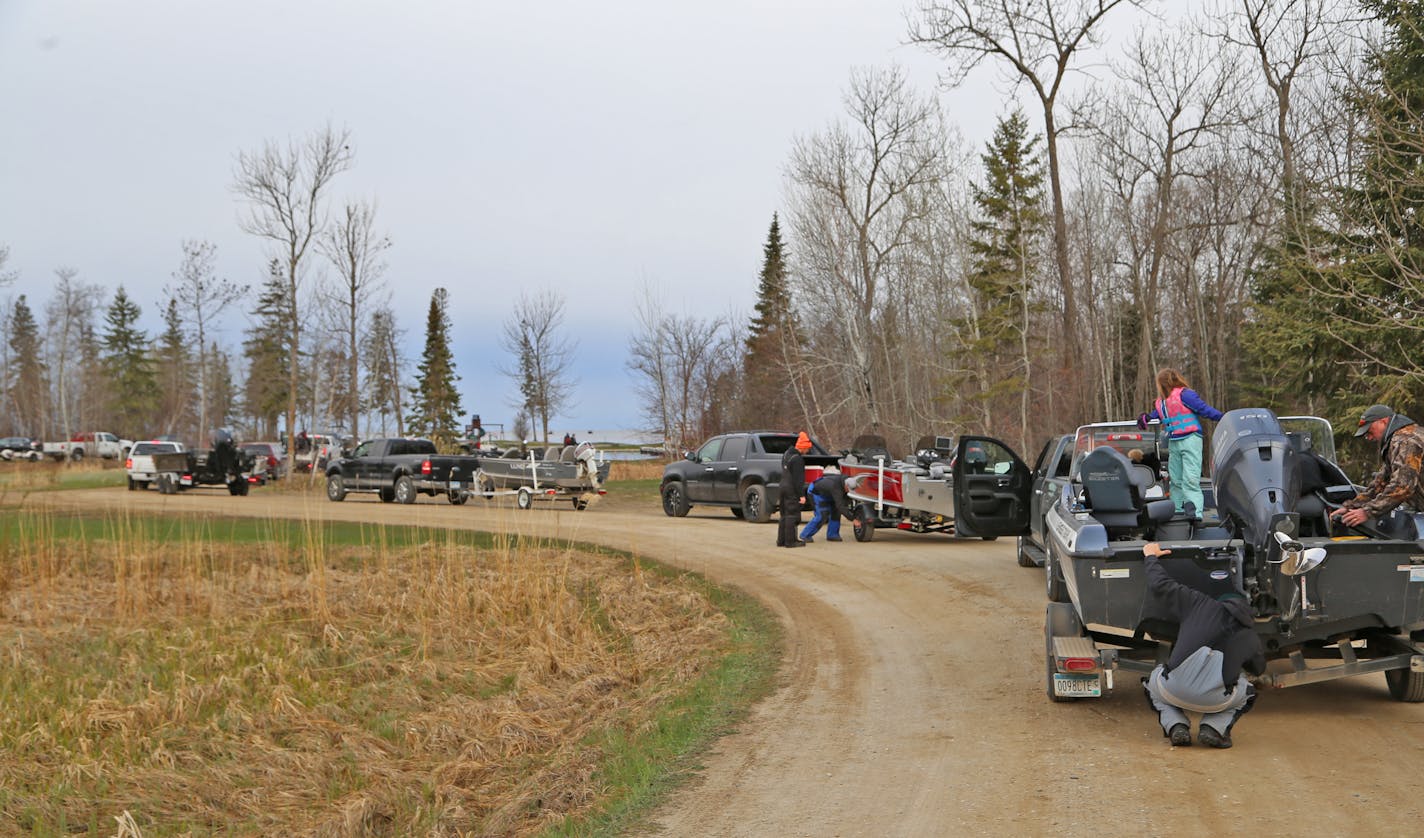 Pickups, boats and trailers lined up, preparing to launch, Saturday morning at West Wind Resort on Upper Red Lake. The resort limited access to its landing this year, but hundreds still were able to launch.