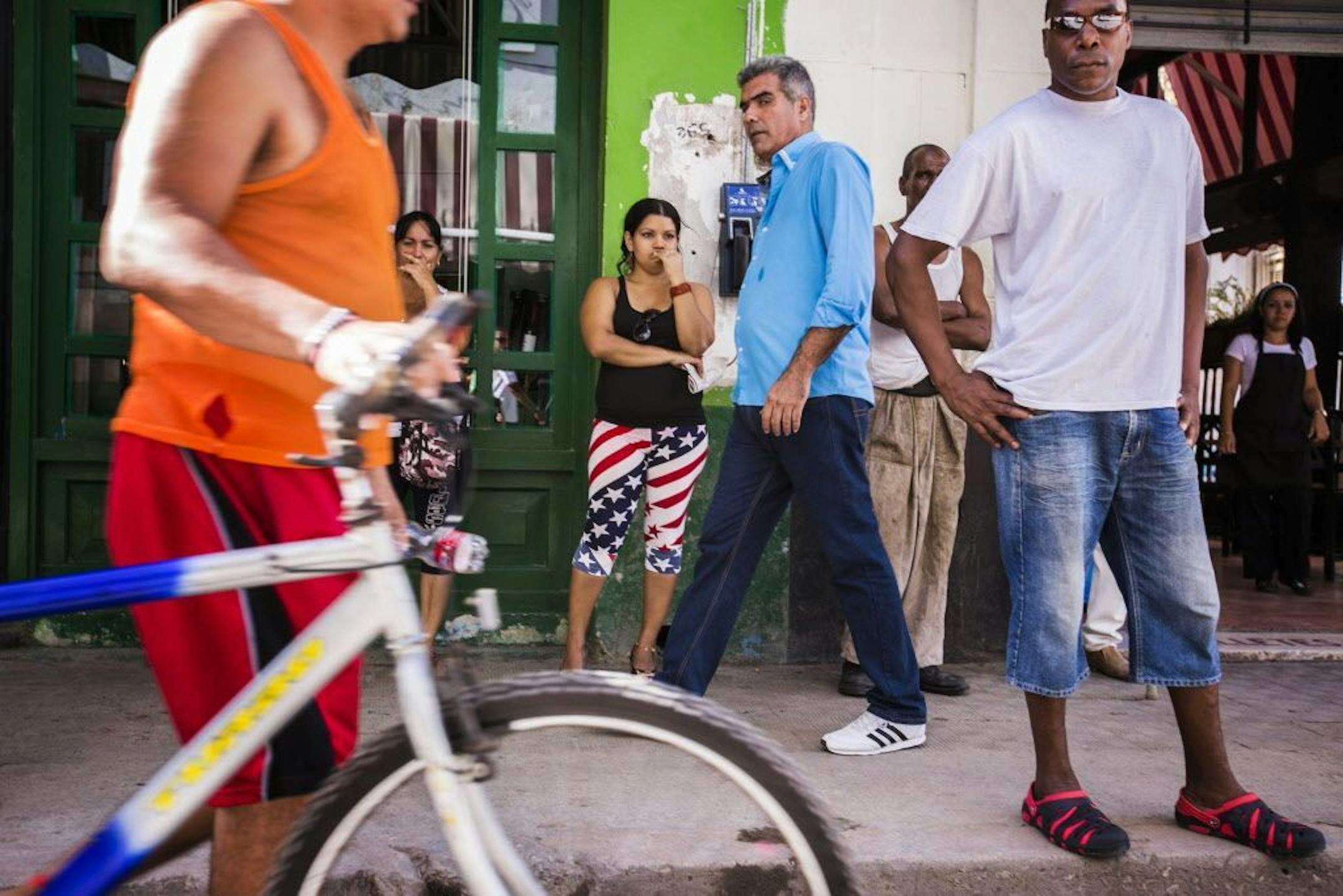 People line up on the street waiting for a bank to open in Old Havana, Cuba on Sunday, May 17, 2015.