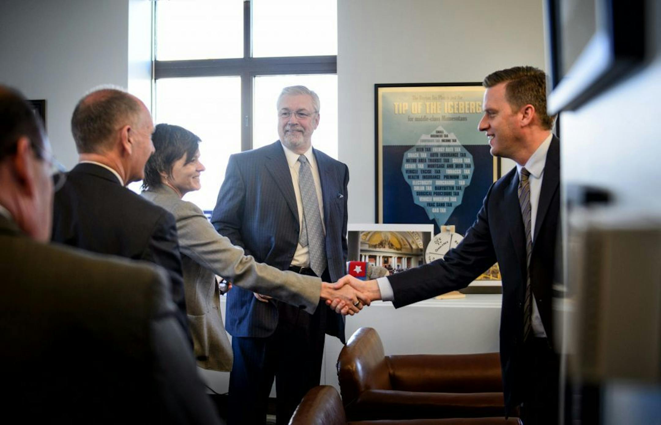 House Speaker Kurt Daudt, right, leaned in to shake hands with MLS board member Wendy Carlson Nelson in his office as Dr. Bill McGuire looked on. On the left is Timberwolves president Chris Wright.