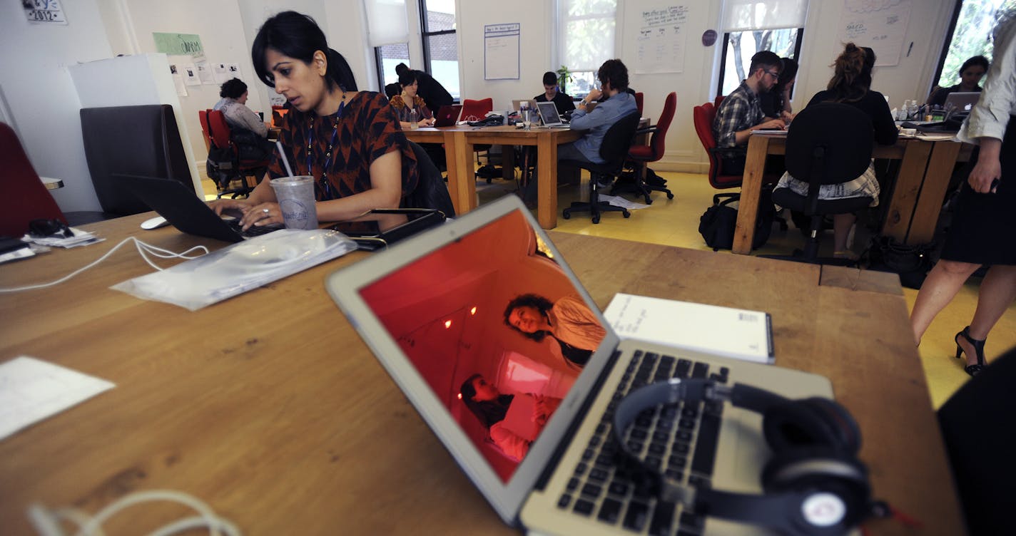 Employees work in the communal open space at What If, a consulting firm, in New York, May 18, 2012. Open offices are growing in popularity, but employees often complain about the noise level and lack of speech privacy. (Jennifer S. Altman/The New York Times)