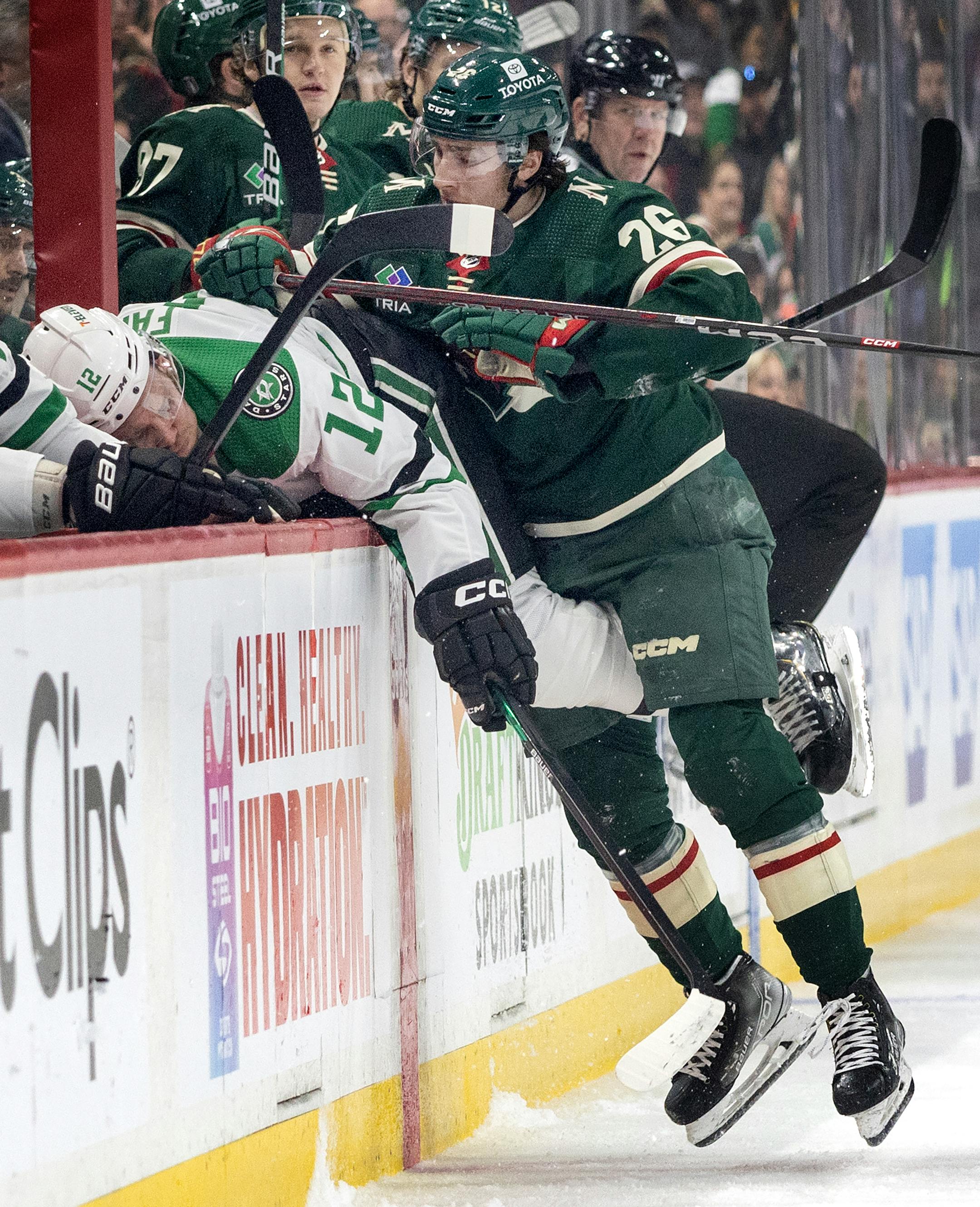 Radek Faksa (12) of the Dallas Stars collides is checked by Connor Dewar (26) of the Minnesota Wild in the first period.