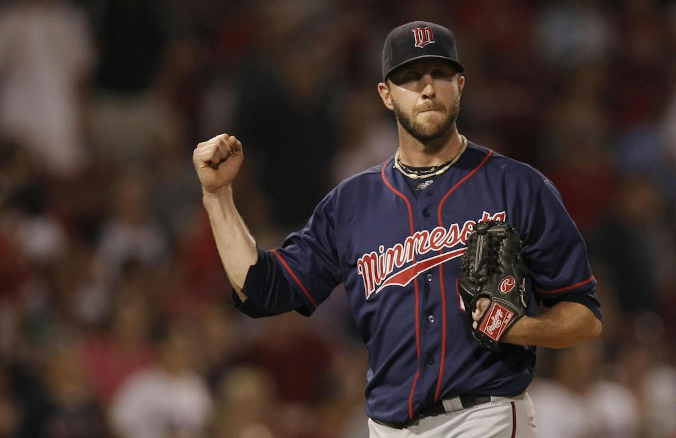 Minnesota Twins relief pitcher Jared Burton pumps his fist after the Twins defeated the Boston Red Sox 6-5 in 10 innings during a baseball game at Fenway Park in Boston, Friday, Aug. 3, 2012.