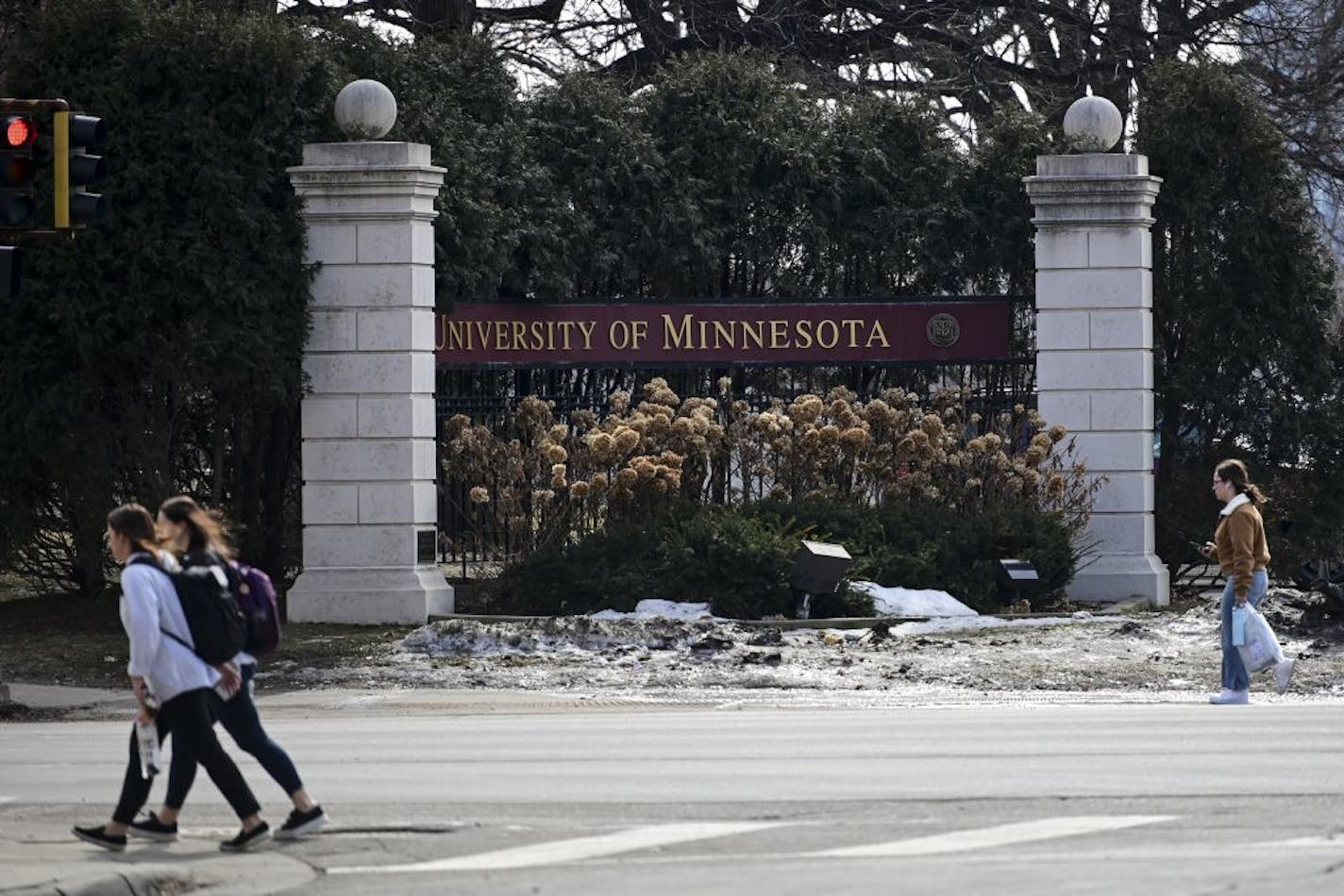 Pedestrians walked past a University of Minnesota sign along University Avenue Wednesday afternoon.