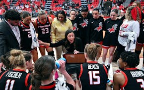 Fairfield coach Carly Thibault-DuDonis, center, speaks with her team during a timeout of a game earlier this month.