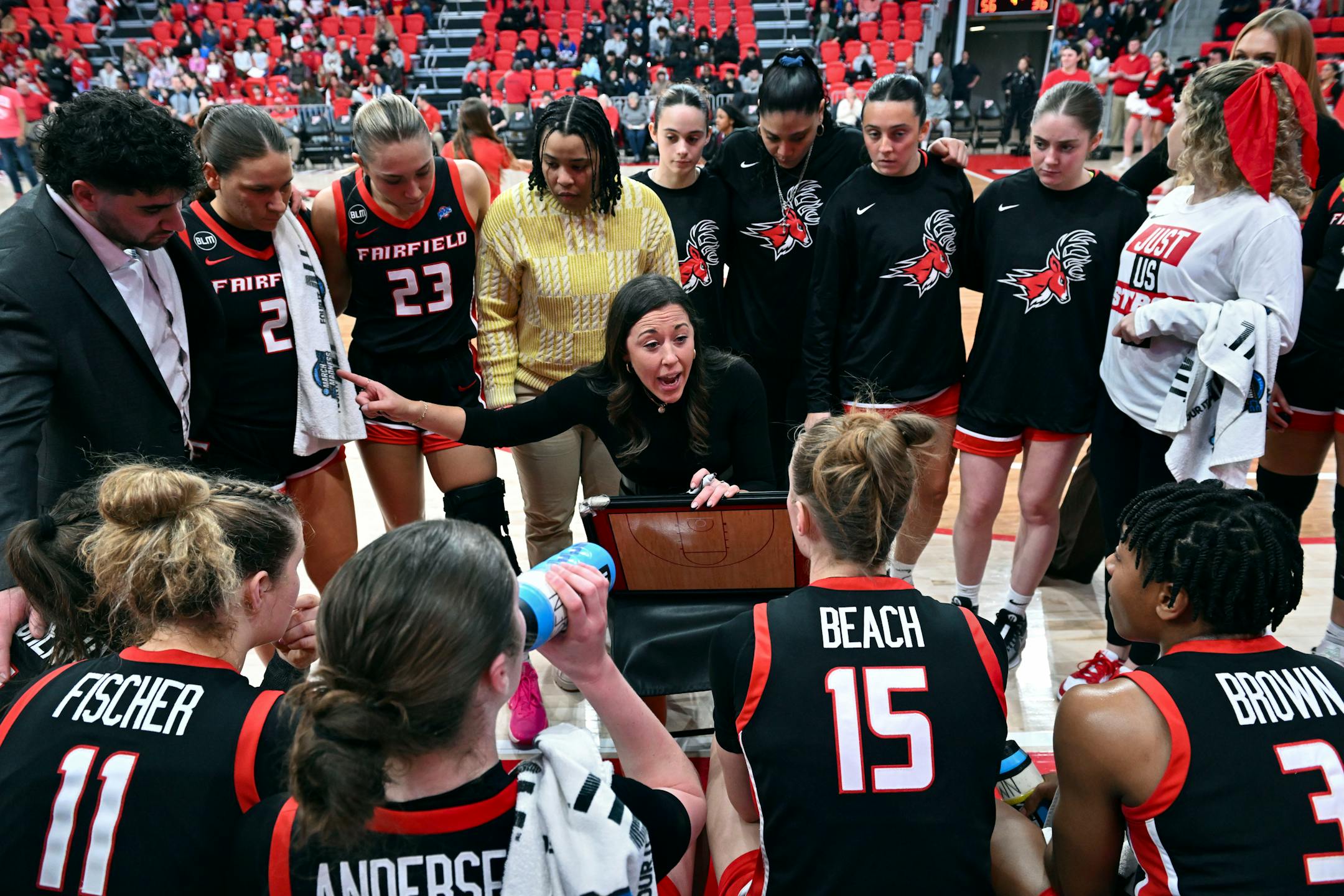 Fairfield coach Carly Thibault-DuDonis, center, speaks with her team during a timeout of a game earlier this month.