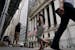 Pedestrians walk past the front of the New York Stock Exchange in New York, Tuesday, June 14, 2022. Wall Street is wobbling between gains and losses T