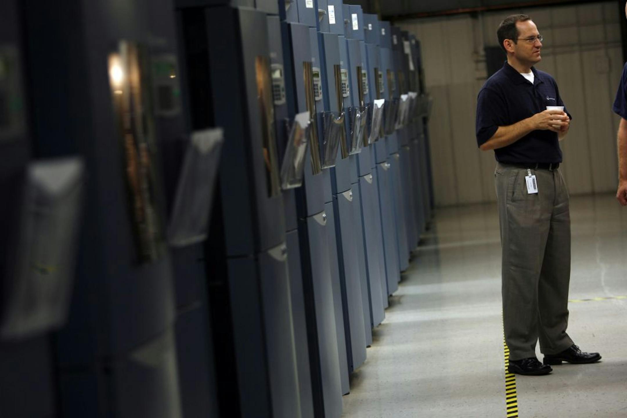 Public relations manager Joe Hiemenz with some of Stratasys' rapid prototyping machines, which spray and bake plastic into precise replicas of new products.