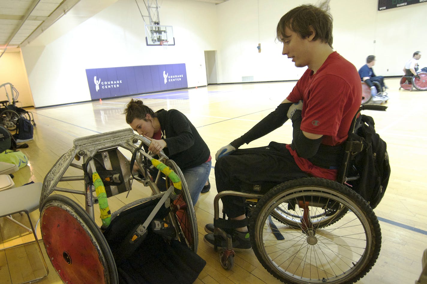 Brittany Wiitala, of Minneapolis, helps pound out a foot plate for Kyle Peterson, of Moose Lake, during an equipment time out at a Minnesota Steelheads practice. Photo by Liz Rolfsmeier, Special to the Star Tribune
