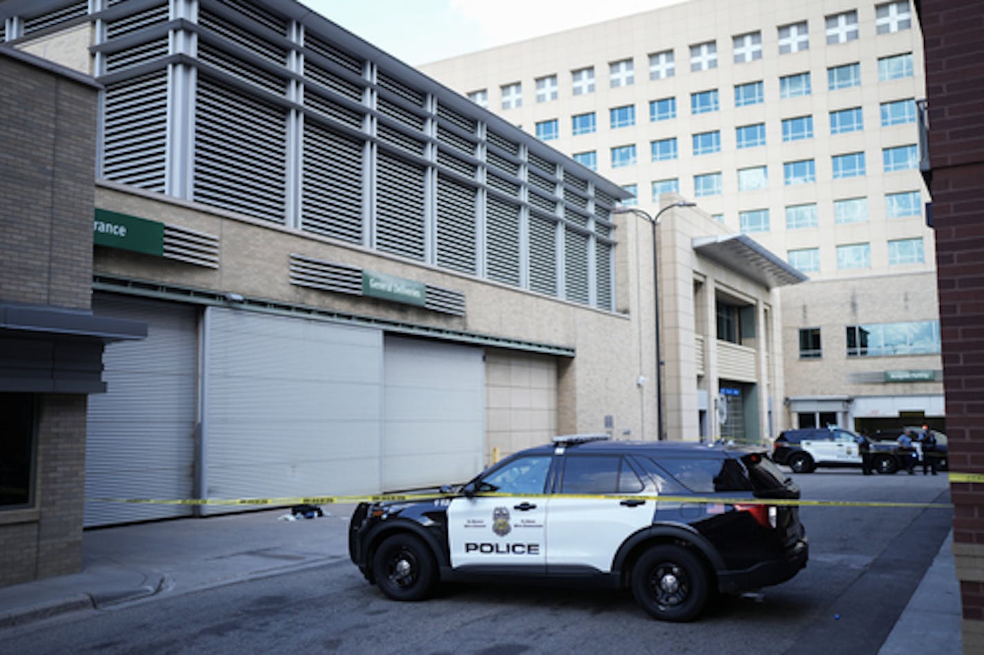 Minneapolis police officers investigated the scene where witnesses said a man working on a window cleaning crew was shot in Minneapolis's North Loop neighborhood on Friday, July 15, 2022.