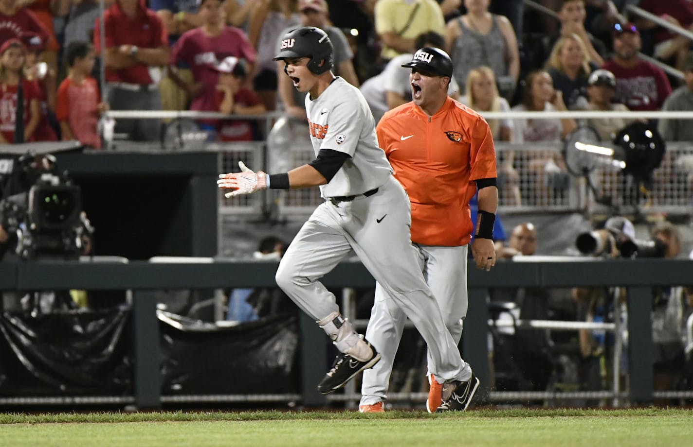 Oregon State's Trevor Larnach (11) celebrates his two-run home run against Arkansas during the ninth inning in Game 2 of the NCAA College World Series baseball finals in Omaha, Neb., Wednesday, June 27, 2018. (AP Photo/Ted Kirk)