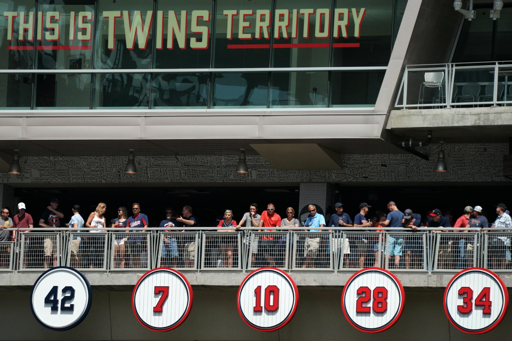 Fans stood near the wall of retired numbers, including the recently added number 7 for Joe Mauer, in the fifth inning.