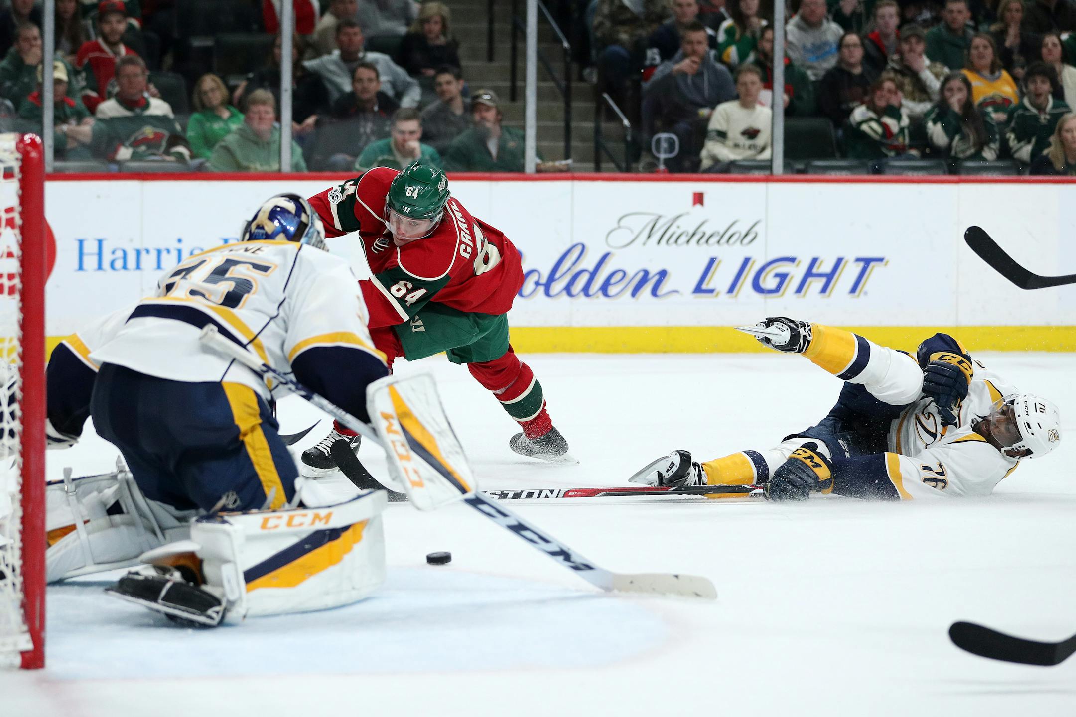 Wild center Mikael Granlund (64) crosses the puck to left wing Jason Zucker (16) who was able to score