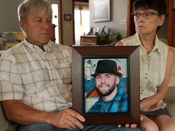 In 2019, Matthew Klaus' parents John and Denise Klaus held a portrait of their deceased son at their home in Oronoco.