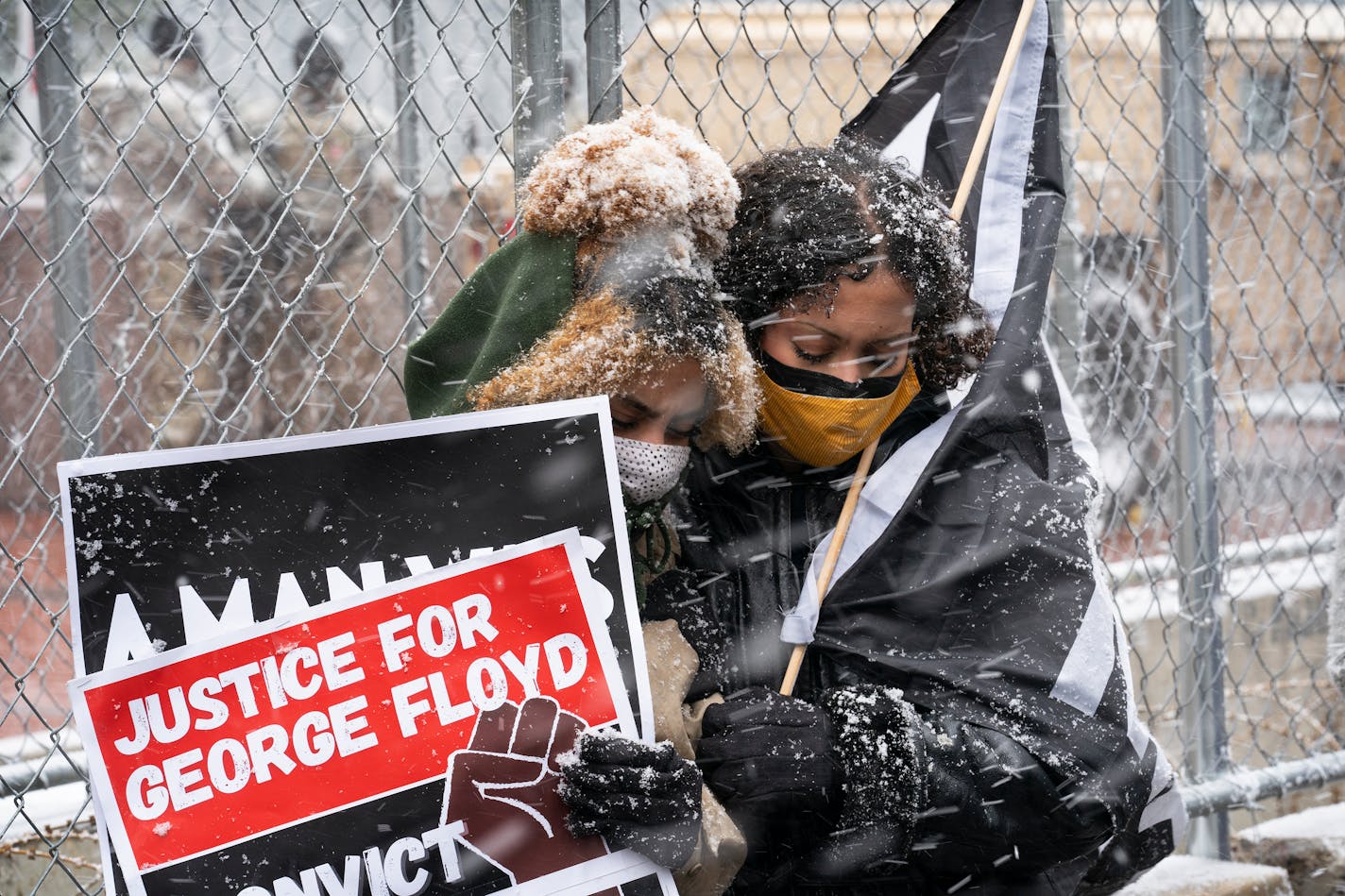 Rogen Abdalla, left, and her sister Rawan Abdalla of Minneapolis hugged each other to stay warm joining protesters who blocked streets near the Hennepin County Government Center to protest concerns of jury selections Monday March 15, 2021 In Minneapolis, MN.] Jerry Holt •Jerry.Holt@startribune.com