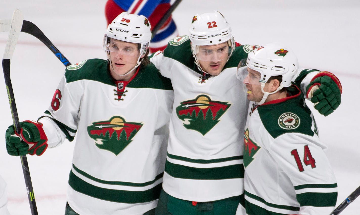 Nino Niederreiter, center, celebrated his first-period goal with Erik Haula, left, and Justin Fontaine.