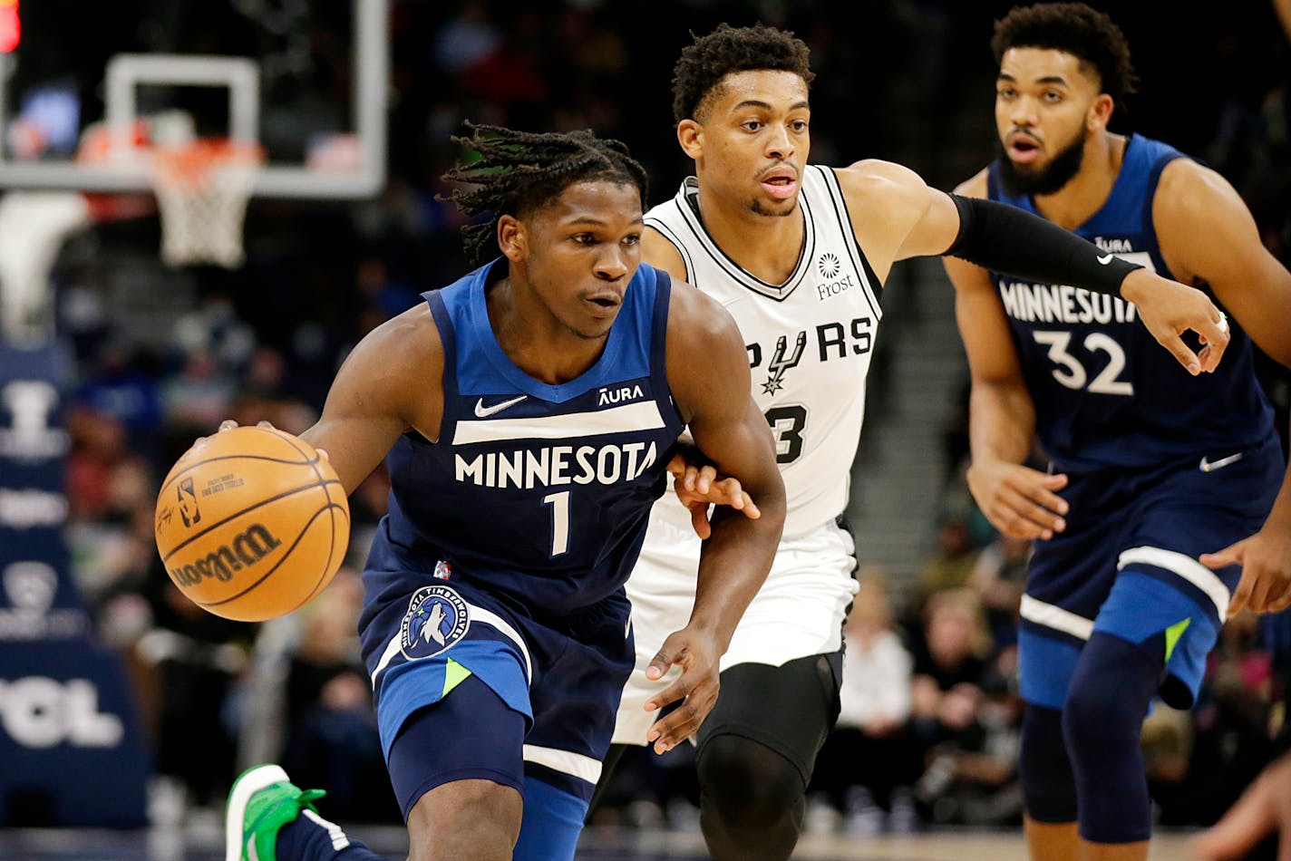 Timberwolves forward Anthony Edwards drives against San Antonio Spurs forward Keldon Johnson in the first half