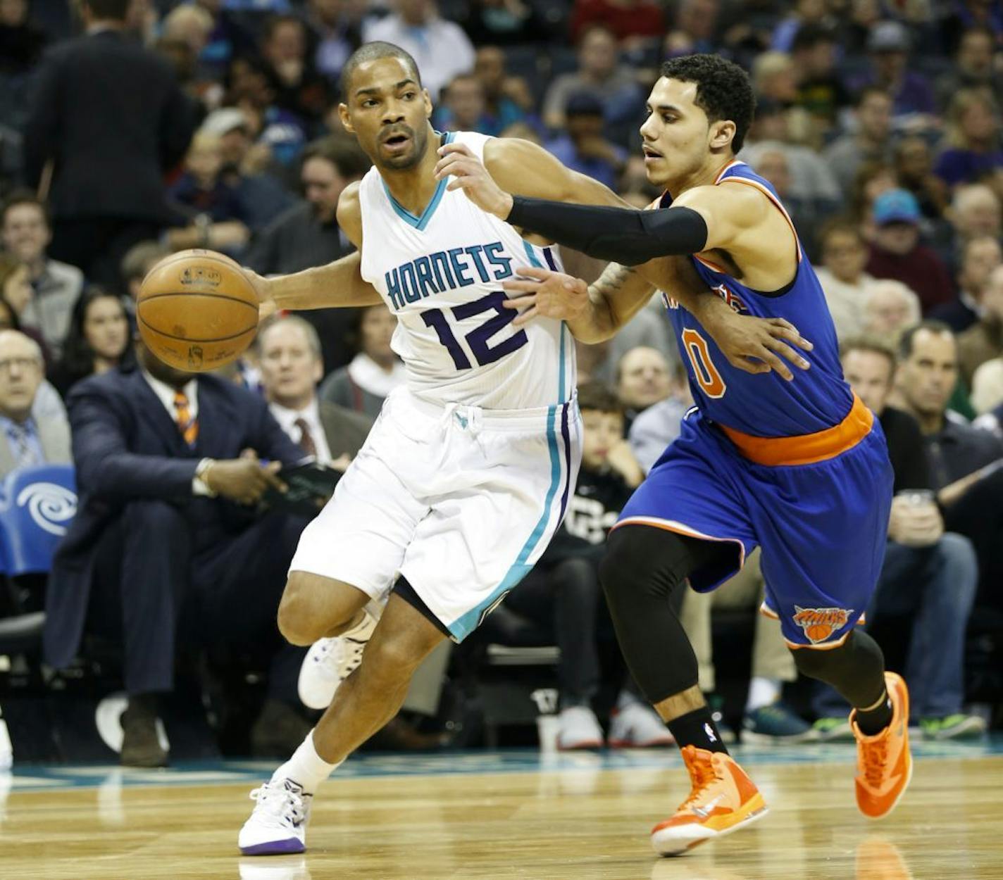 Charlotte Hornets guard Gary Neal, left, looks for room to pass against New York Knicks guard Shane Larkin in the first half of an NBA basketball game Saturday, Jan. 24, 2015, in Charlotte, N.C. Charlotte won 76-71.