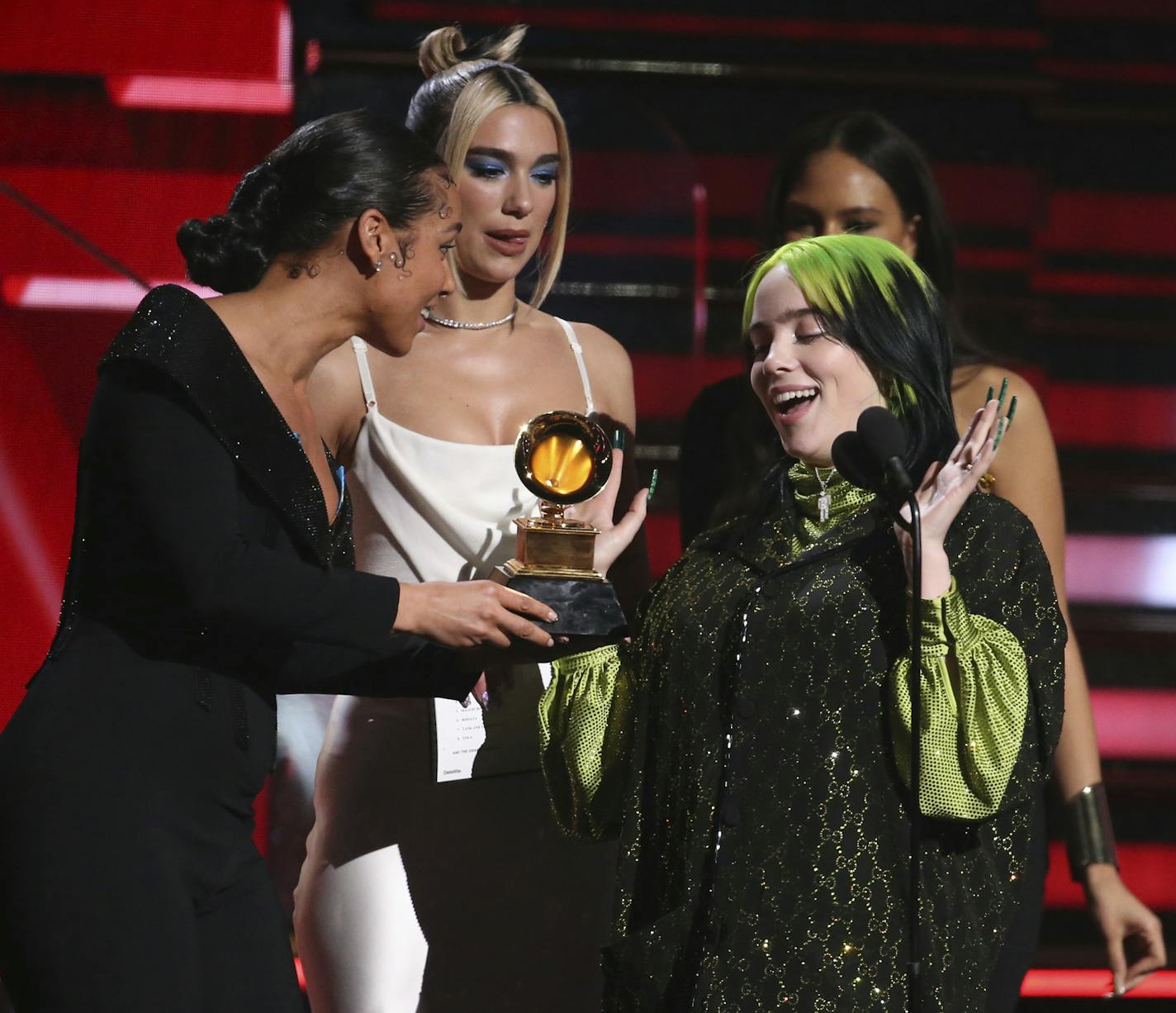 Alicia Keys, from left, and Dua Lipa present Billie Eilish with the award for best new artist at the 62nd annual Grammy Awards on Sunday, Jan. 26, 2020, in Los Angeles. (Photo by Matt Sayles/Invision/AP)