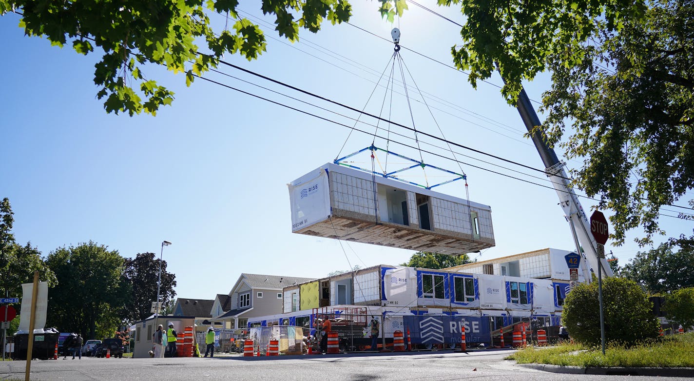 27 modules were stacked into place at the new Mod42 apartment complex being built in Minneapolis. The pre-fabricated units built and installed by Rise Modular will make 30 residences in the complex which will also have amenities like a dog wash, bicycle storage and a gym. Assembly of the units will take only a week, and will rent between $1,100 and $1,300. ] Shari L. Gross ¥ shari.gross@startribune.com Modular apartment pods were stacked into place to create a 3-story apartment building in Minne