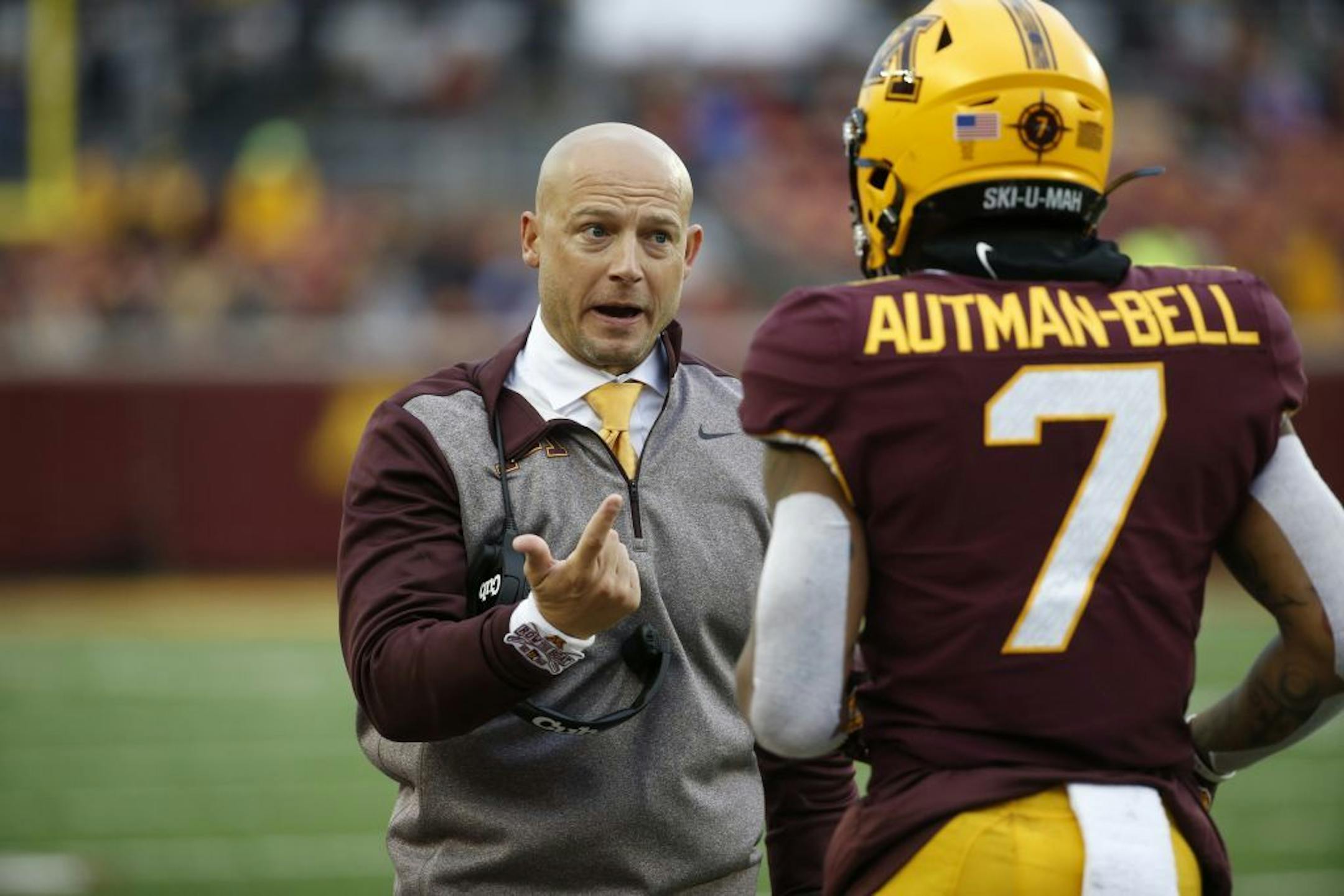 P.J. Fleck, left, talks with wide receiver Chris Autman-Bell.