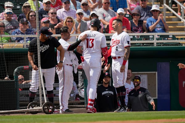 Minnesota Twins Joey Gallo (13) is greeted at the dugout after hitting a home run against Detroit during spring training.
