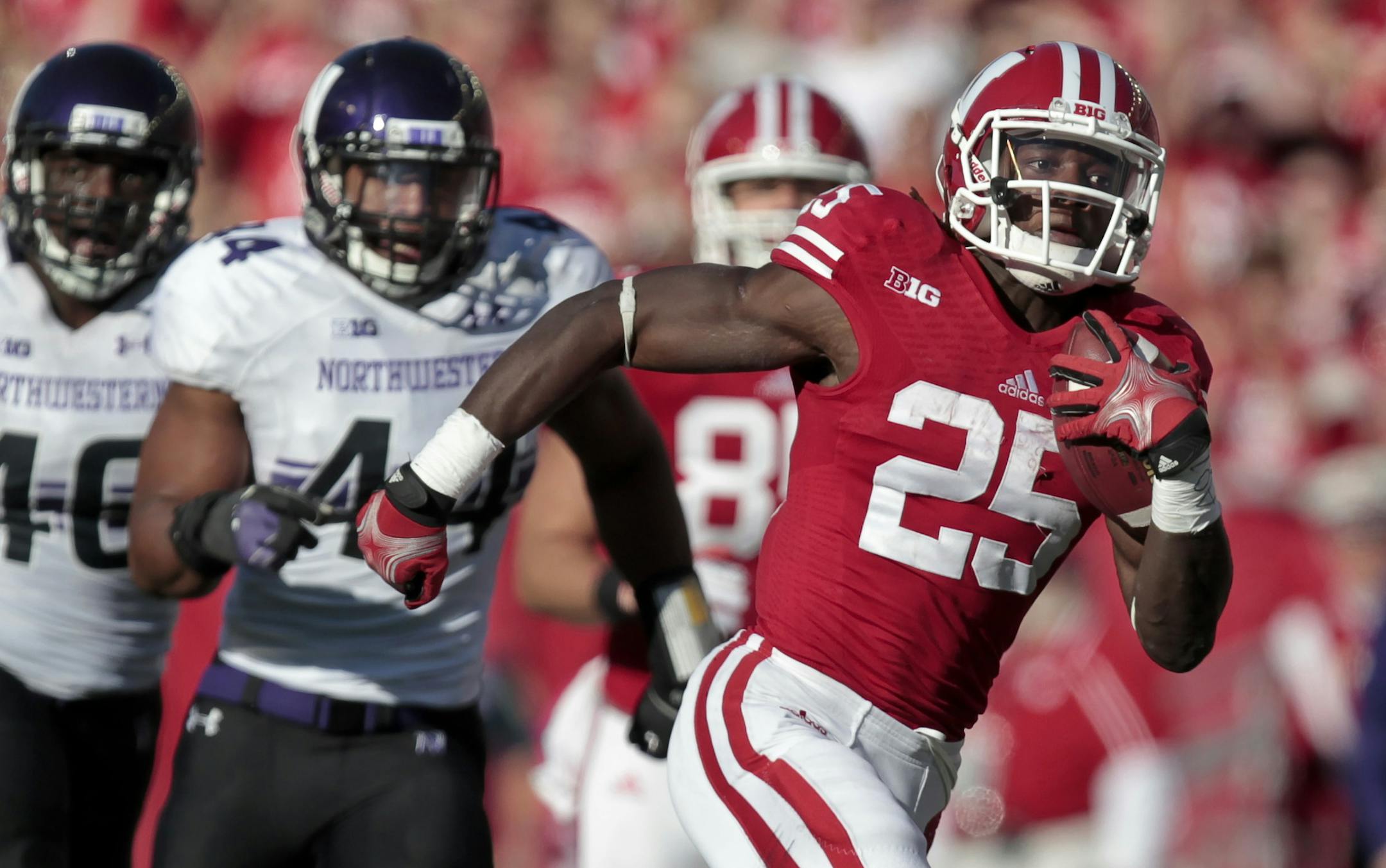 Wisconsin running back Melvin Gordon ran past Northwestern's Collin Ellis and Chi Chi Ariguzo on a 71-yard touchdown run during the first half in Madison, Wis., on Saturday.