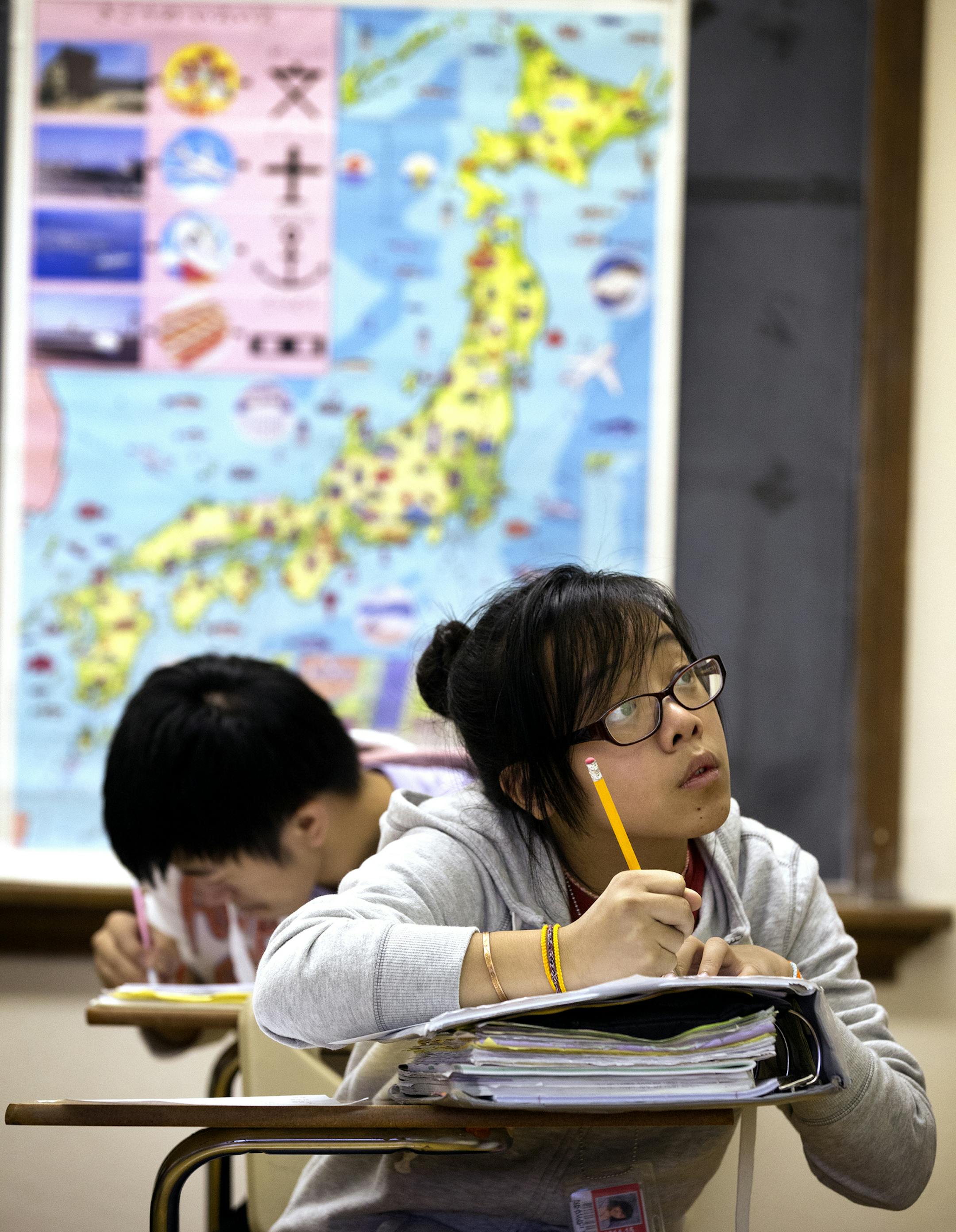 Global citizens: At Patrick Henry High, teacher Kazuko Shiba led a Japanese III class; students Kia Lao, 17, Gem Fields, 16, and Samantha Yang, 16, worked on an exercise; and Nkaujci Thao, 16, took notes. More than 65 percent of district high-schoolers study a second language.