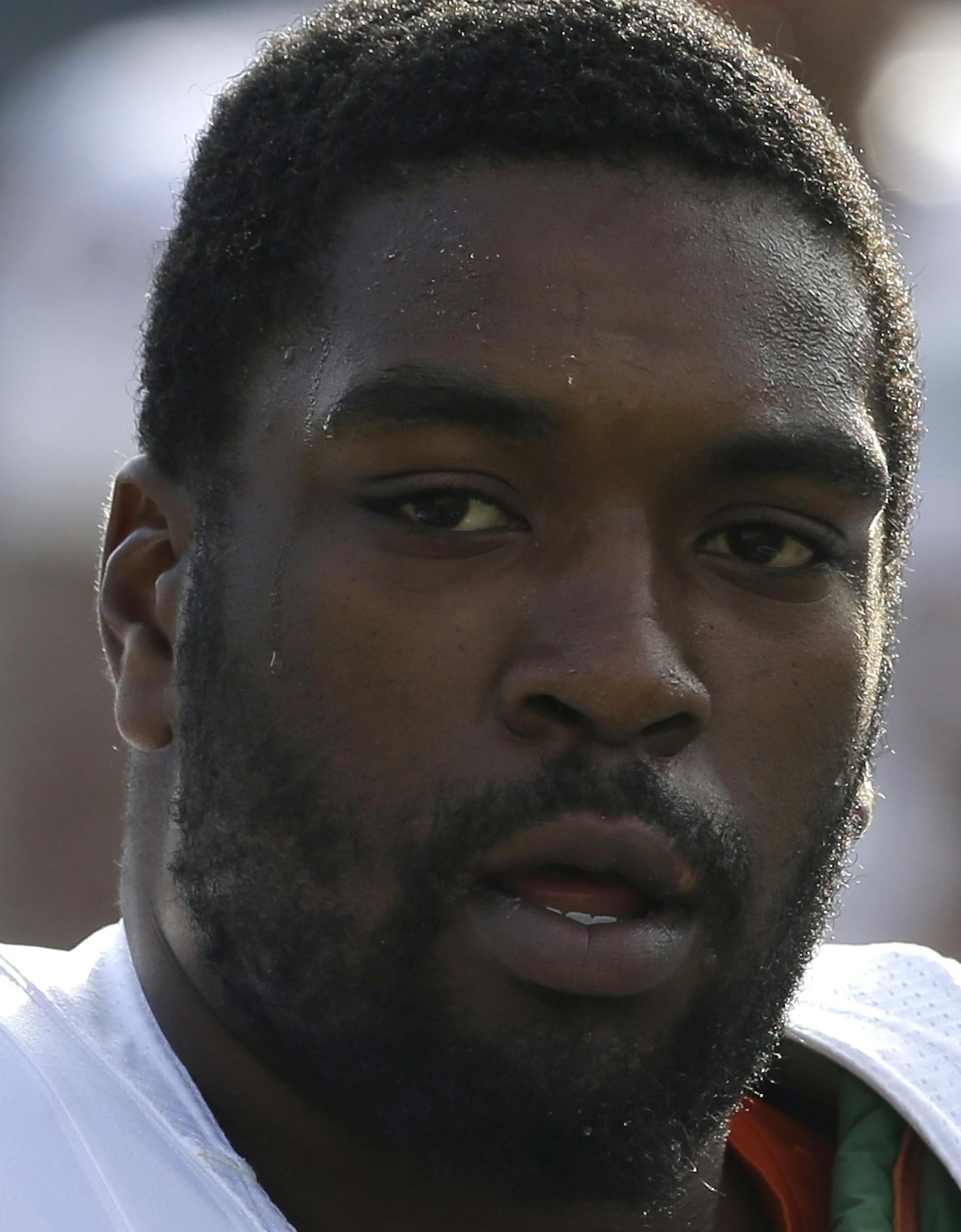 Miami's Seantrel Henderson (77) stretches during pre-game warmups prior to an NCAA college football game against Duke in Durham, N.C., Saturday, Nov. 16, 2013. (AP Photo/Gerry Broome) ORG XMIT: OTK109.JPG
