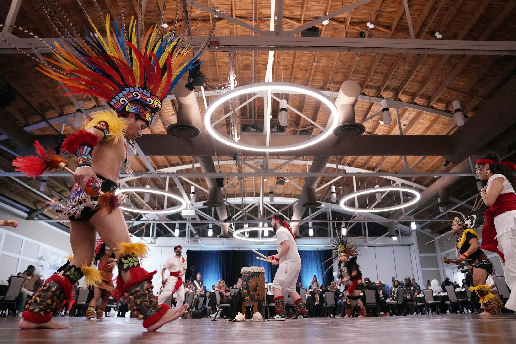 Jesus Rojas, left, with the group Kalpulli Yaocenoxtli performs a ceremonial dance during an event to mark one year since Daunte Wright was fatally shot by former Brooklyn Center officer Kimberly Potter.