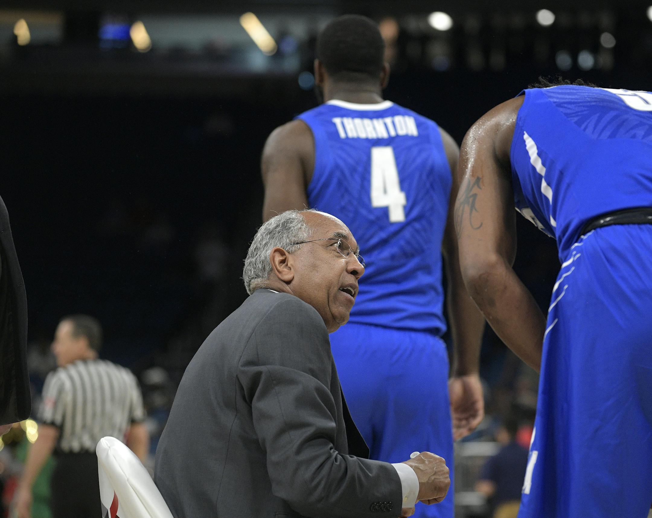 Memphis head coach Tubby Smith talks to guard Kareem Brewton Jr. (5) during a timeout in the first half of an NCAA college basketball semifinal game against Cincinnati at the American Athletic Conference tournament Saturday, March 10, 2018, in Orlando, Fla. (AP Photo/Phelan M. Ebenhack)
