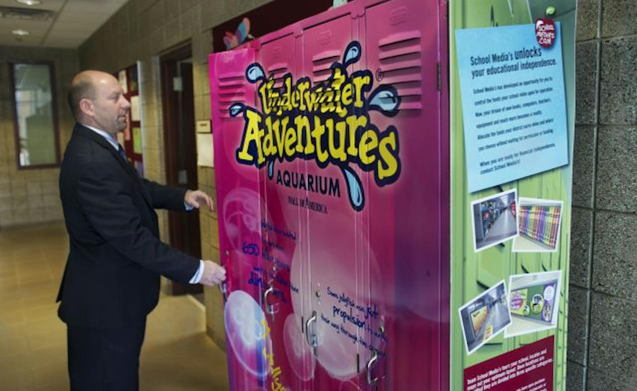Centennial School Superintendent Paul Stremick shows what the lockers would look like with this sample mockup in the hallway just outside the schools district administration office.