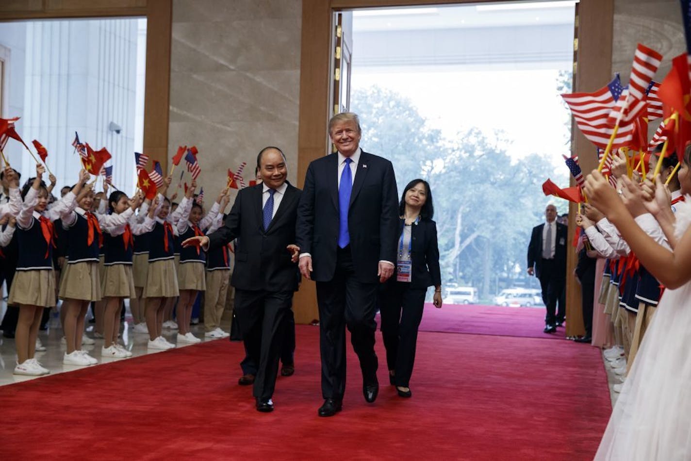 President Donald Trump walks with Vietnamese Prime Minister Nguyen Xuan Phuc at the Office of Government Hall, Wednesday, Feb. 27, 2019, in Hanoi.