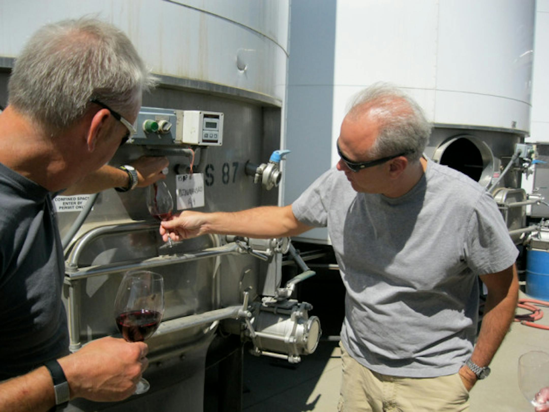 David pouring Gary some wine out of tank (before barreling); it's nice to see and taste wine "in process"