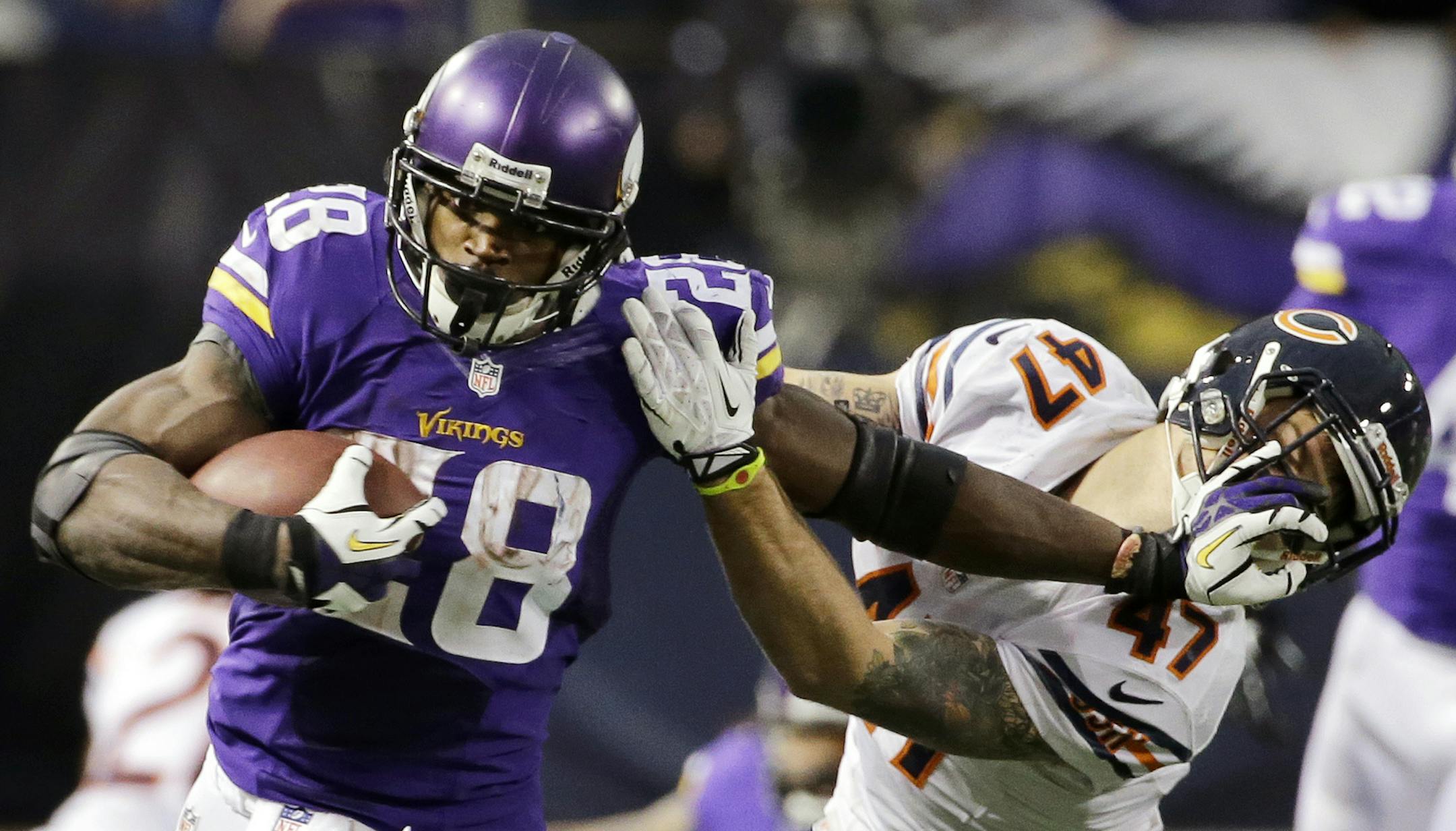 FILE - In this Dec. 1, 2013, fikle photo, Minnesota Vikings running back Adrian Peterson, left, tries to break a tackle from Chicago Bears free safety Chris Conte during the fourth quarter of an NFL football game in Minneapolis. A federal judge has cleared the way for Peterson to be reinstated. U.S. District Judge David Doty issued his order Thursday, Feb. 26, 2015, less than three weeks after hearing oral arguments. (AP Photo/Ann Heisenfelt, File) ORG XMIT: MIN2015041021435329