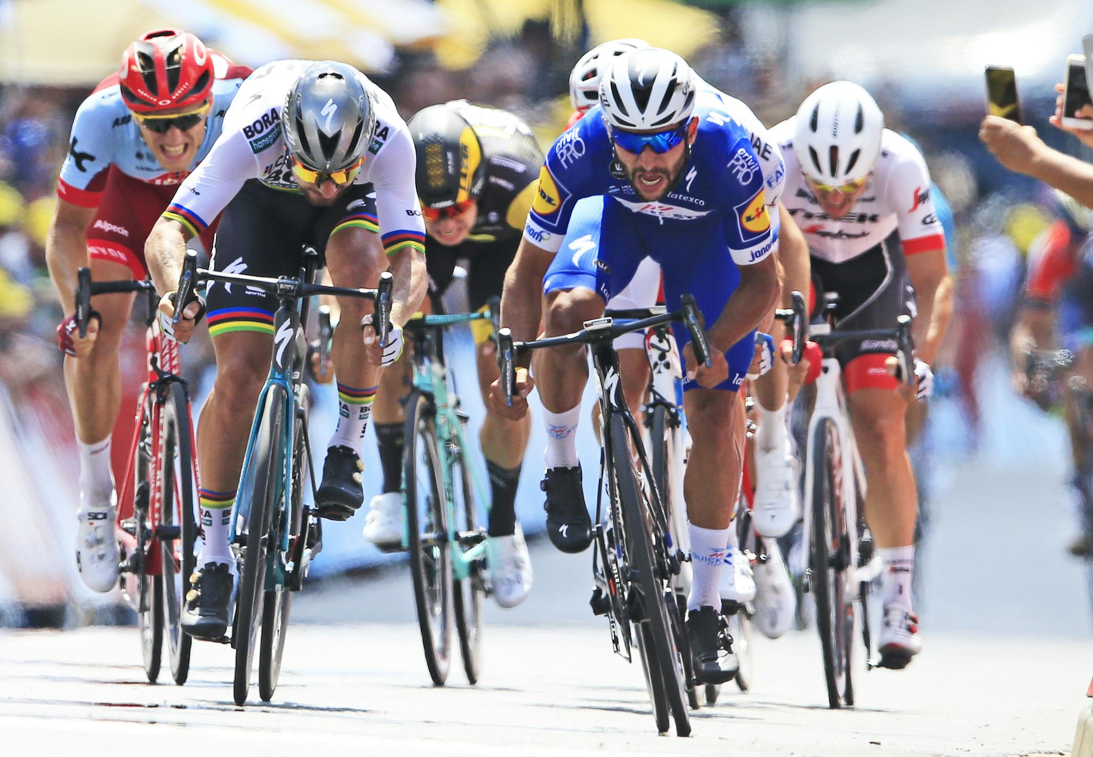 Colombia's Fernando Gaviria, right, crosses the finish line ahead of Peter Sagan of Slovakia, left, to win the first stage of the Tour de France cycling race over 201 kilometers (124.9 miles) with start in Noirmoutier-en-L'Ile and finish in Fontenay Le-Comte, France, Saturday, July 7, 2018. (AP Photo/Peter Dejong)