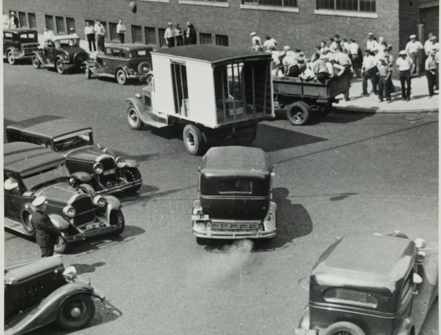 A delivery truck &#x2014; a police decoy &#x2014; was cut off by a pickup crammed with protesters at a downtown Minneapolis intersection. A police car trailed behind.