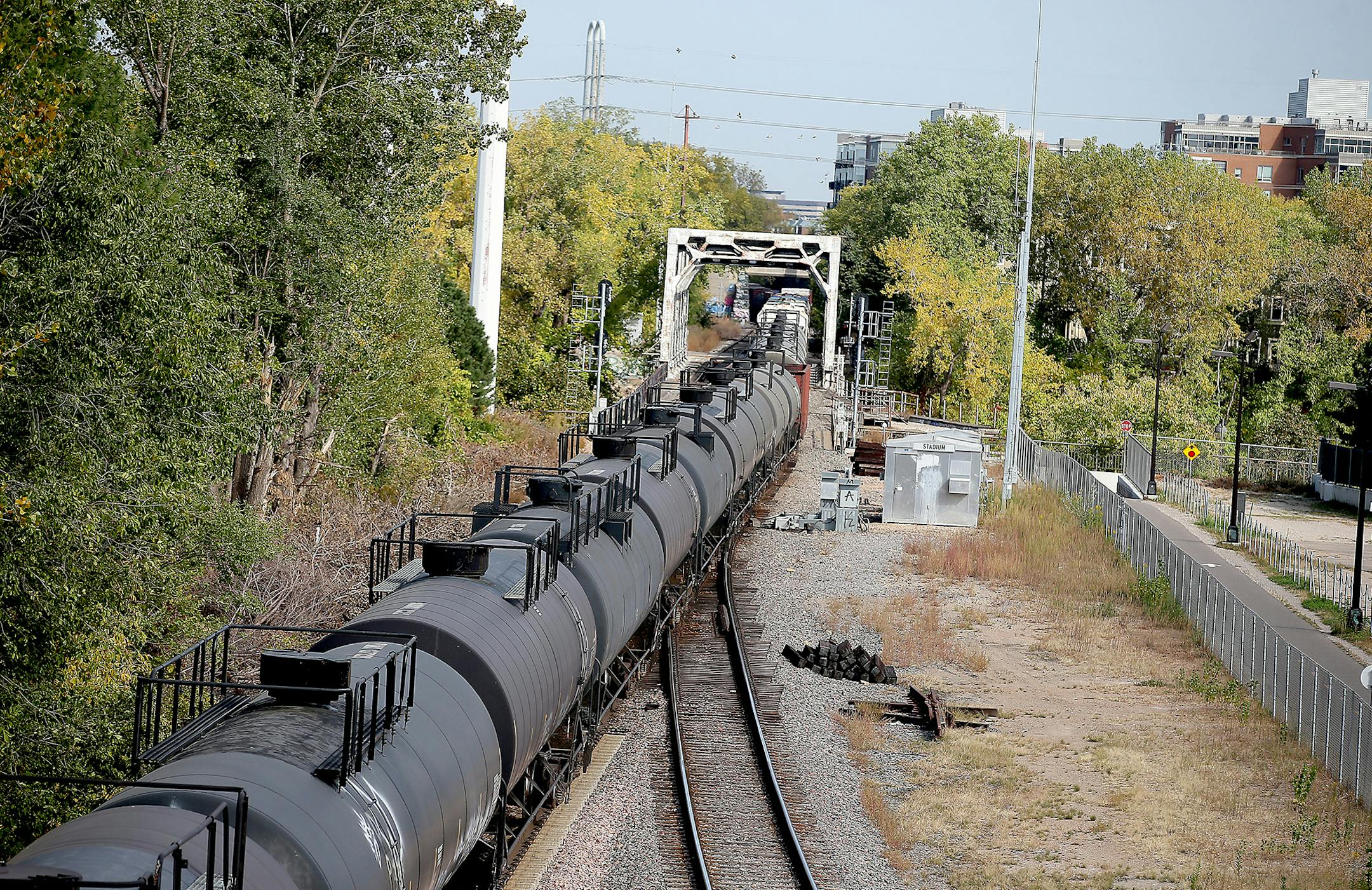 A train made its way along the tracks near downtown Minneapolis, MN, Tuesday, Oct. 6, 2015. growing number of trains that each carry at least 1 million gallons of oil from North Dakota have been entering the Twin Cities via the western suburbs on a route that sends them and their hazardous cargo through downtown Minneapolis. (Elizabeth Flores/Star Tribune via AP) MANDATORY CREDIT; ST. PAUL PIONEER PRESS OUT; MAGS OUT; TWIN CITIES LOCAL TELEVISION OUT ORG XMIT: MIN2015102919011314