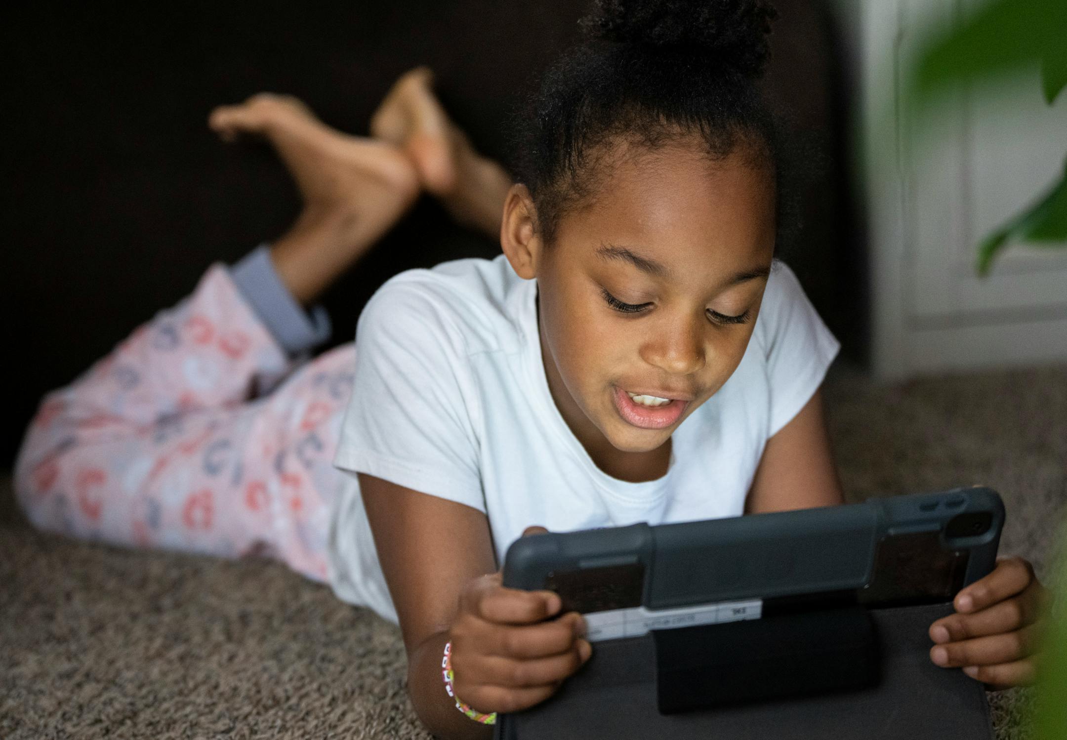 Jalei Haynes, 8, colors on her iPad after distance learning for the day during the snow storm.