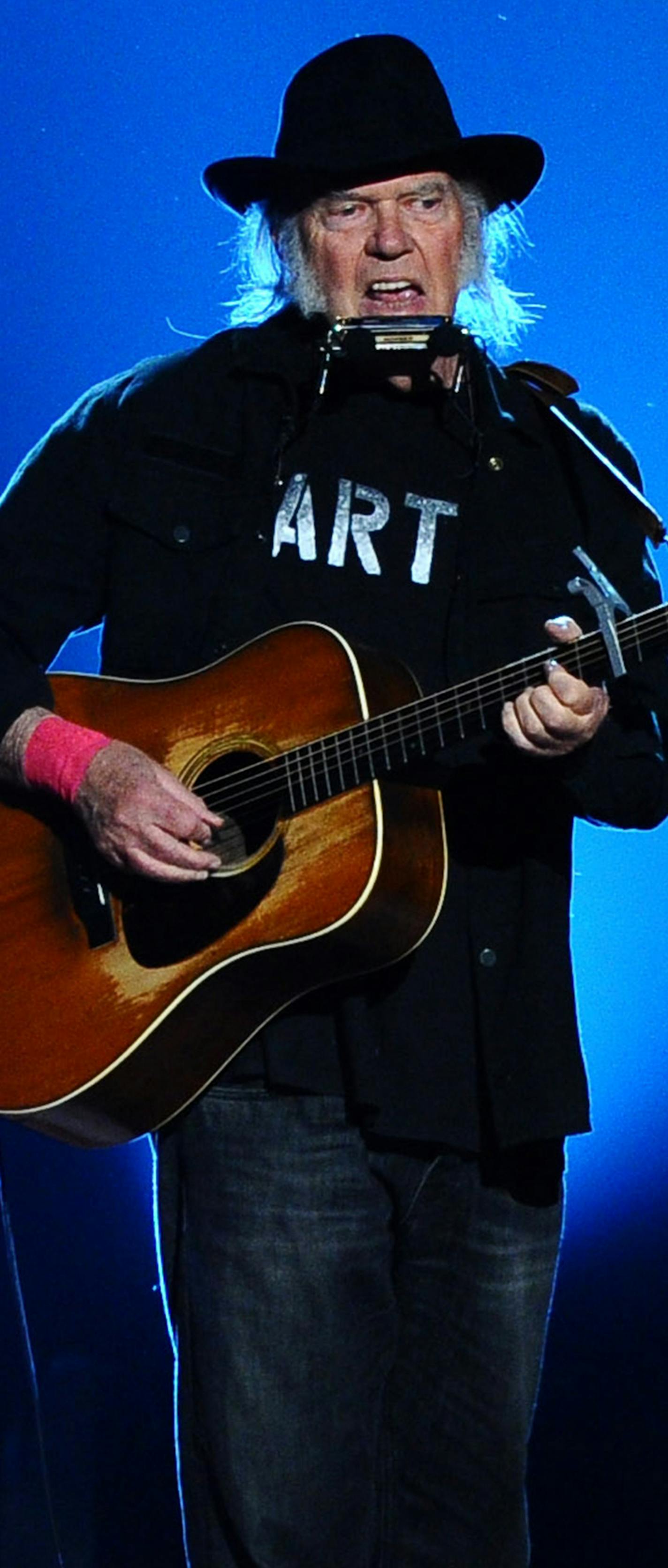 Neil Young performs on stage at the 2015 MusiCares Person of the Year show at the Los Angeles Convention Center on Friday, Feb. 6, 2015, in Los Angeles. (Photo by Vince Bucci/Invision/AP) ORG XMIT: INVW