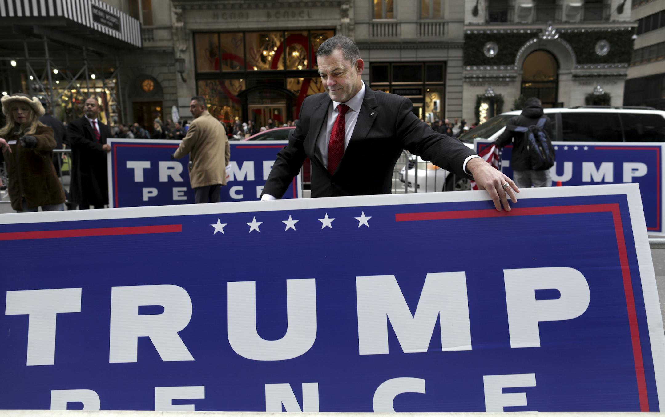 A group of Donald Trump supporters with large signs from the his successful presidential campaign outside Trump Tower on Fifth Avenue in New York, Nov. 20, 2016. (Yana Paskova/The New York Times)